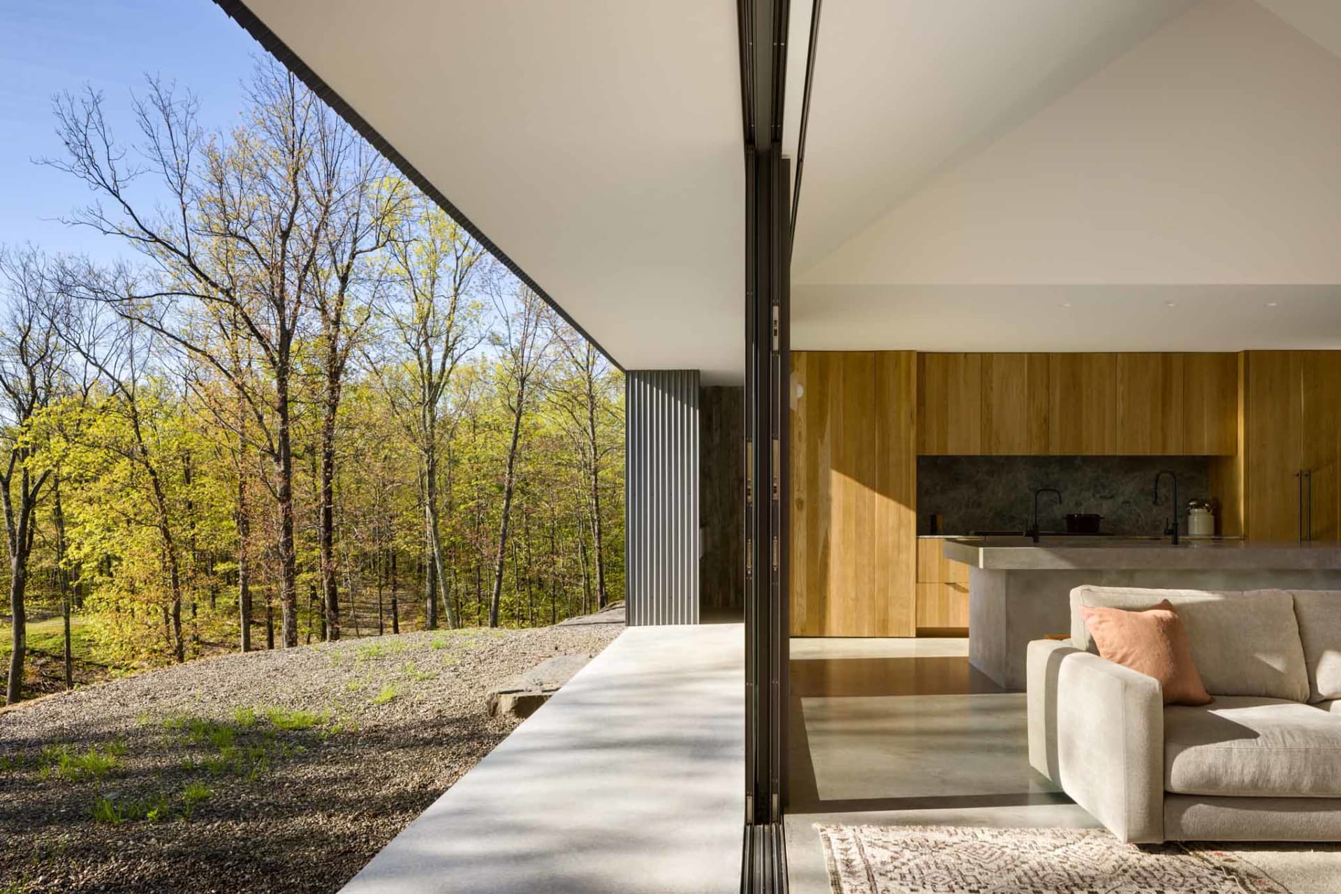 A modern residential interior with concrete flooring and wooden accents.