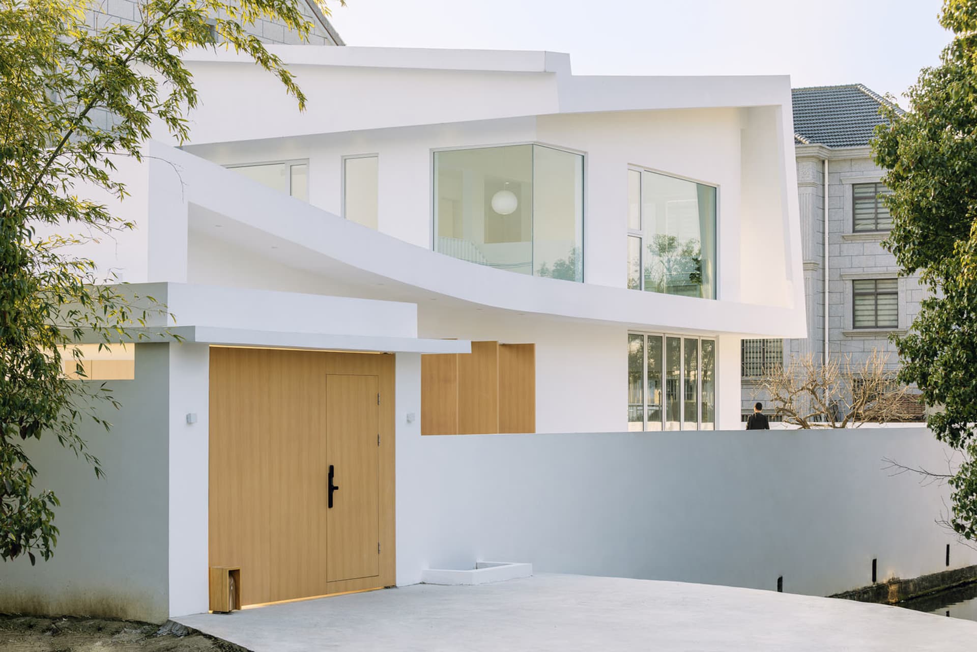 Modern residential house with white exterior and large glass windows