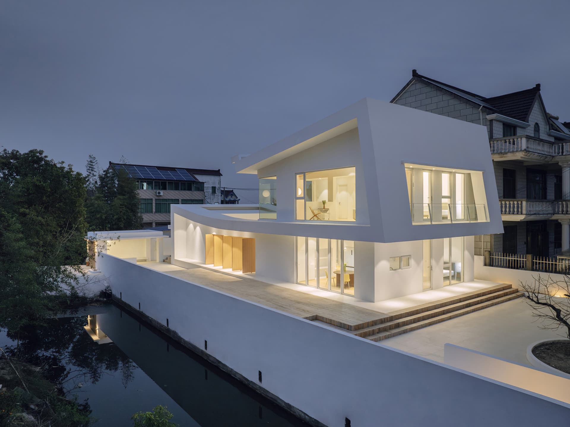 A modern residential house with concrete and glass exterior materials.