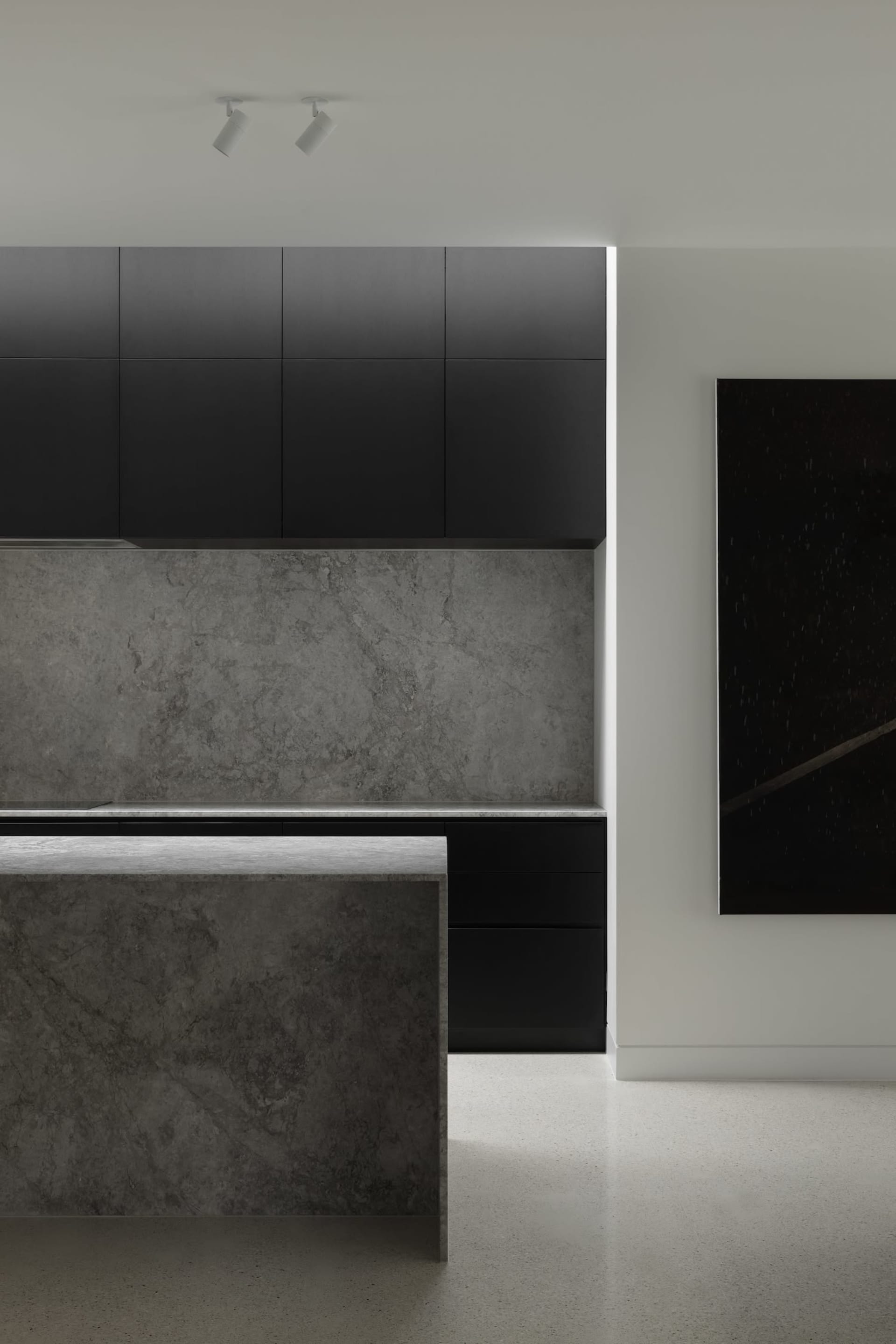 Modern kitchen featuring gray granite countertops and backsplash