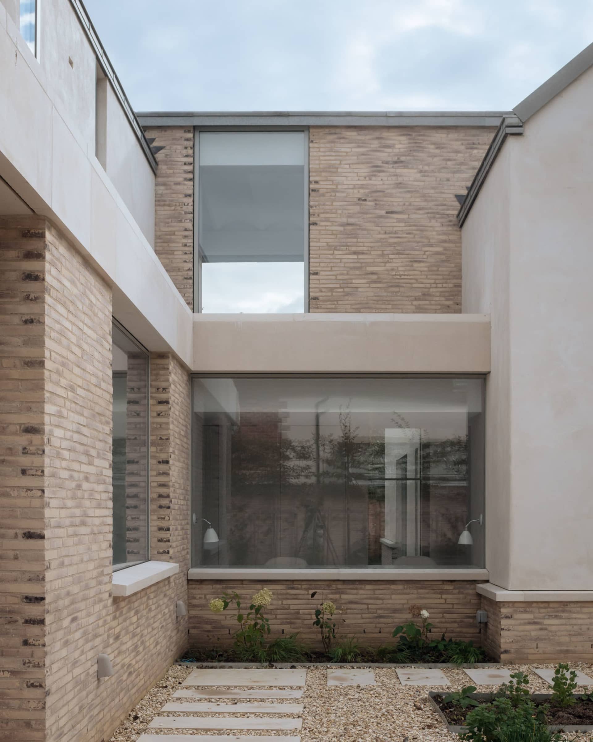 Modern house with brick exterior and large windows.