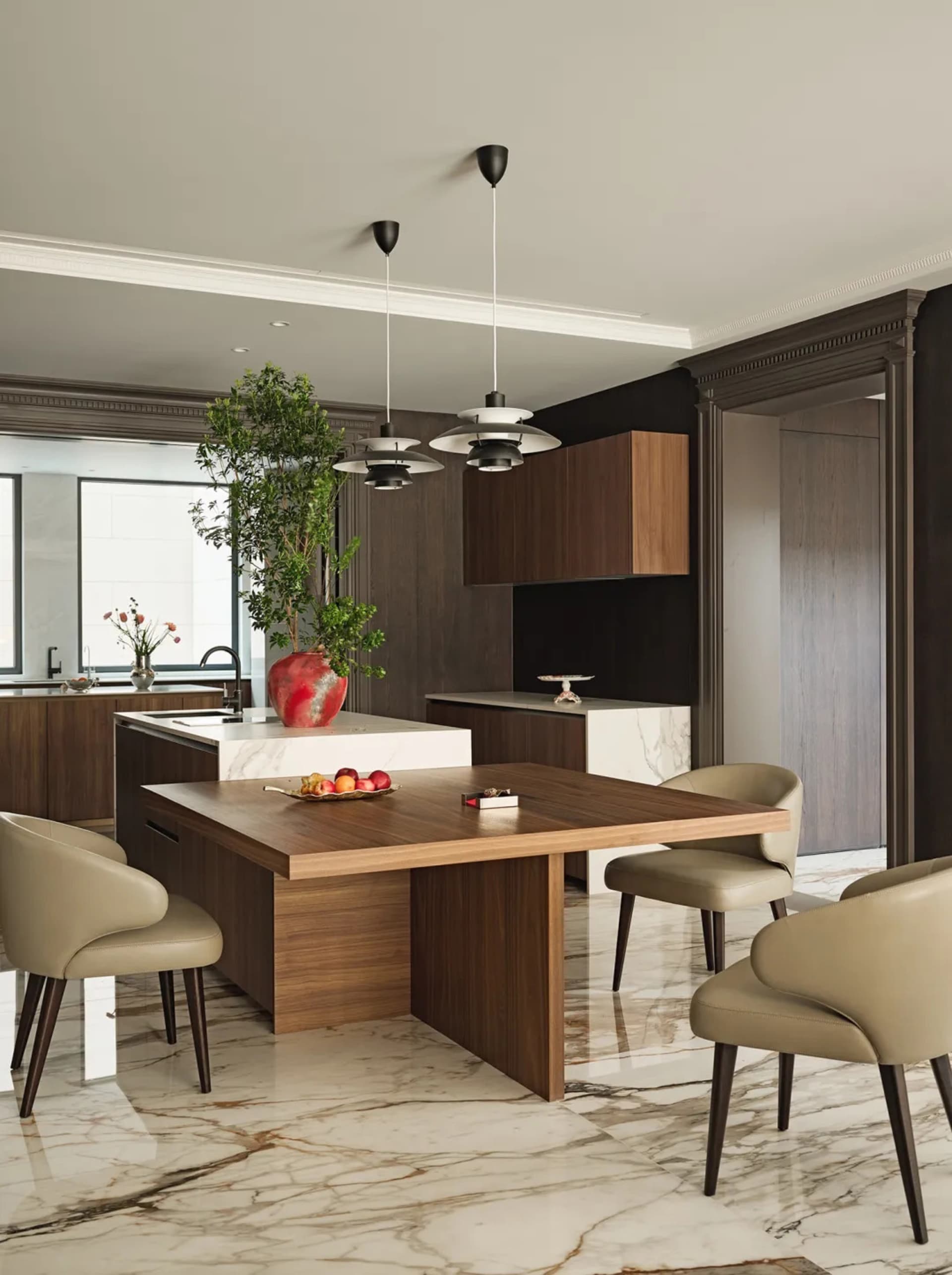 Contemporary kitchen with marble countertops, wooden cabinets, and glass pendant lights.