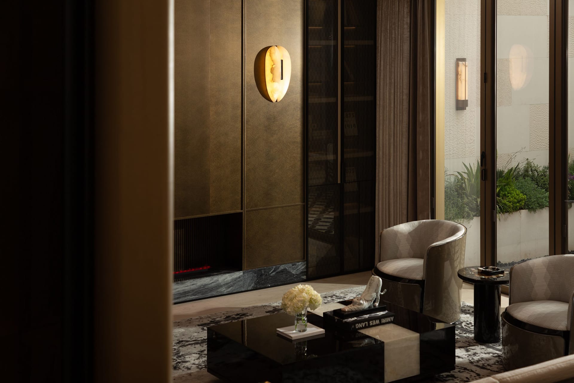 A modern living room with metallic elements and glass features.