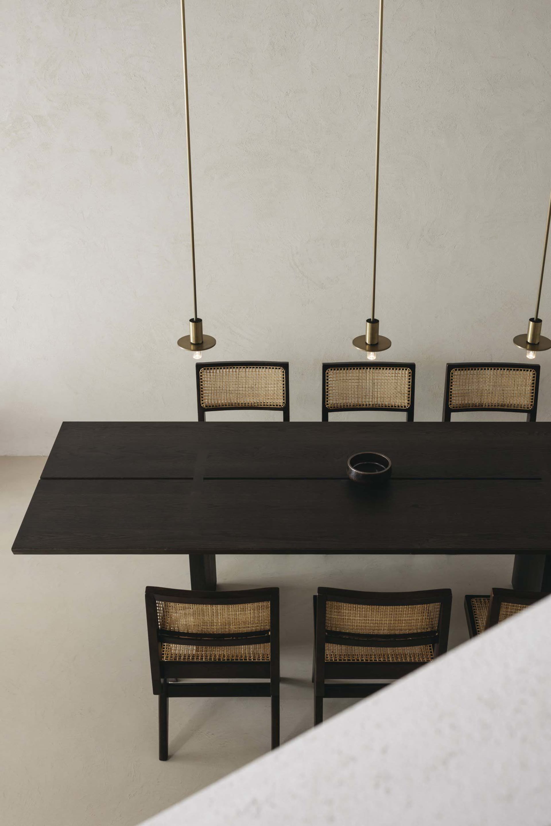 A modern dining room with a wooden table and chairs, minimalistic design and geometric shapes.