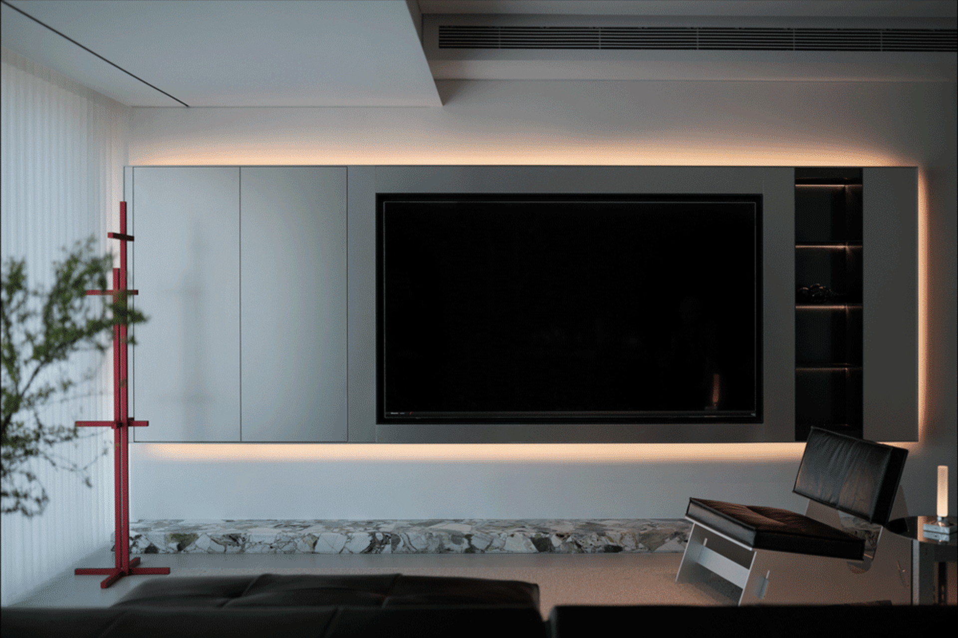Modern living room with minimalist design, featuring a sleek TV cabinet, leather seating, and a marble accent wall.