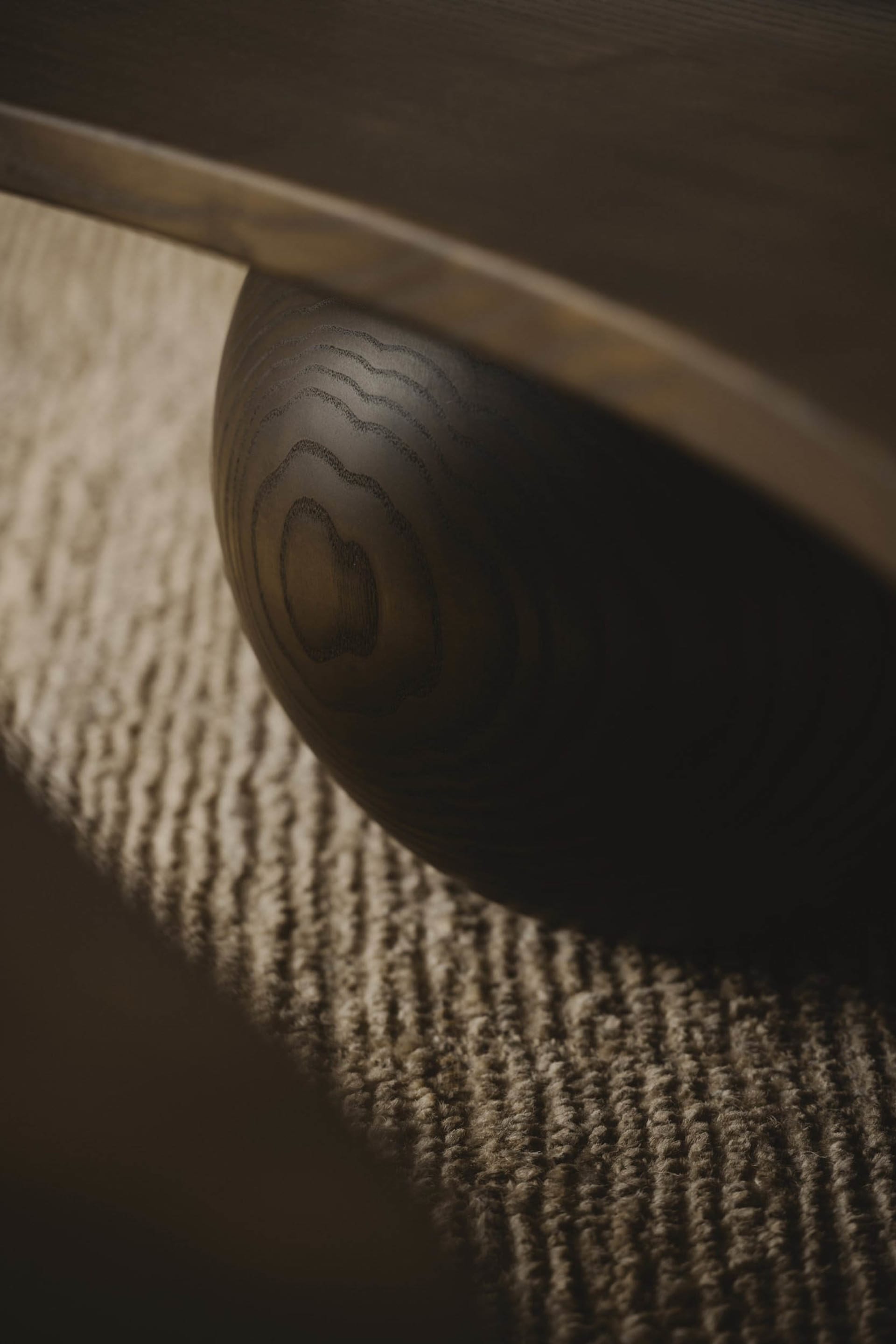 Close-up of a round wooden furniture carving on a textured carpet
