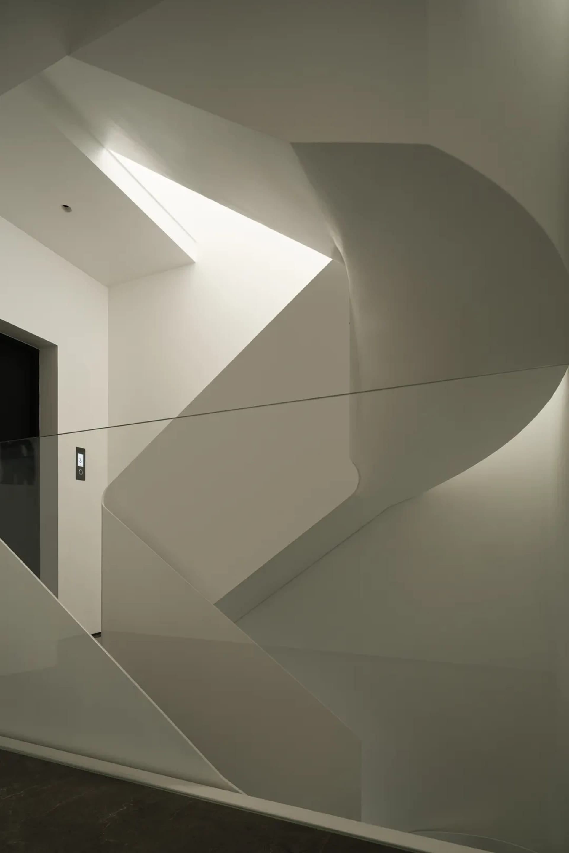 Photograph of modern stairs featuring glass materials and clean lines.