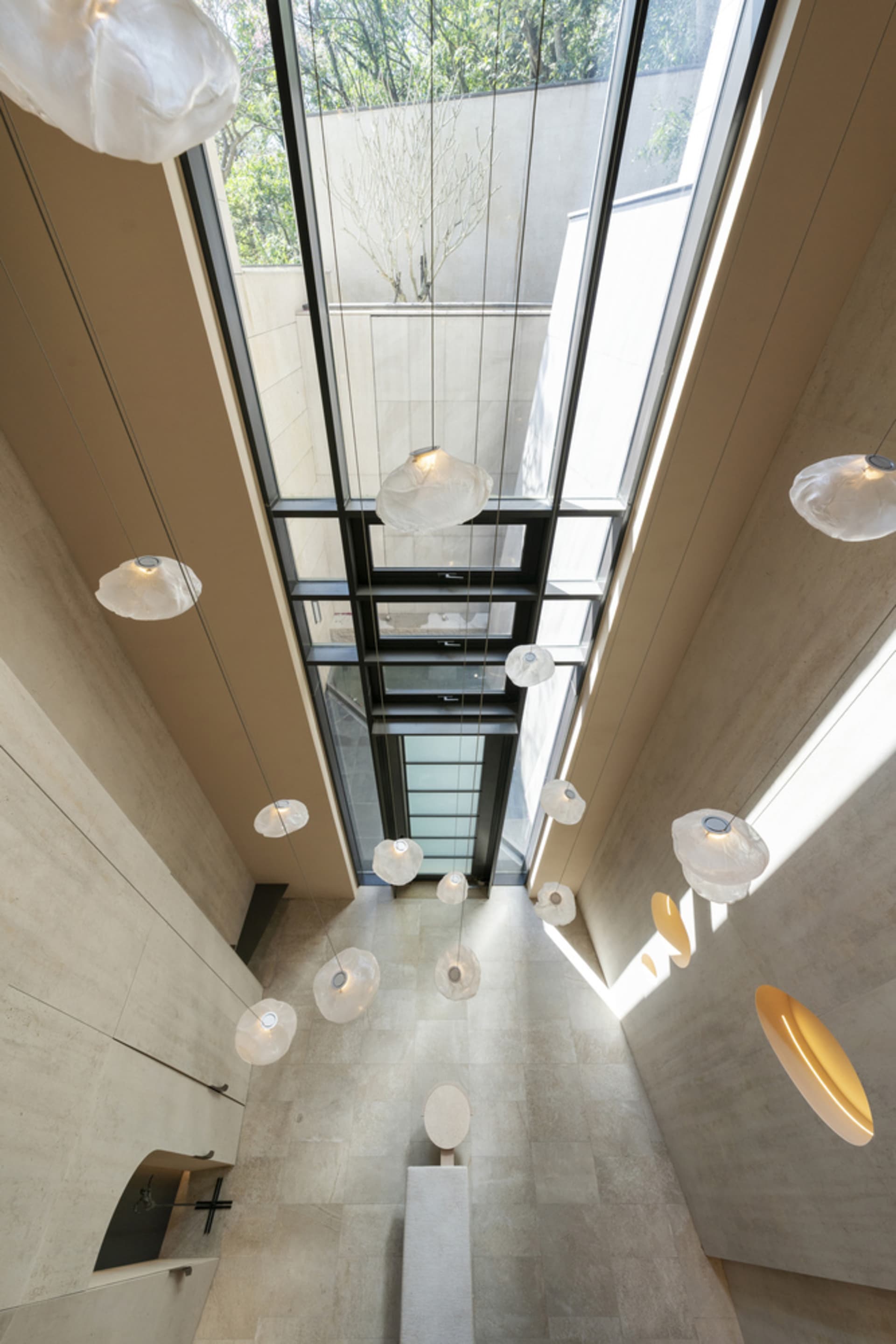 Modern interior featuring contemporary lighting fixtures and concrete finishes.