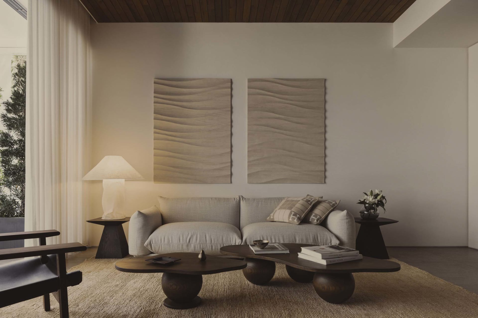 A modern living room with neutral-toned decor and minimalist design elements.