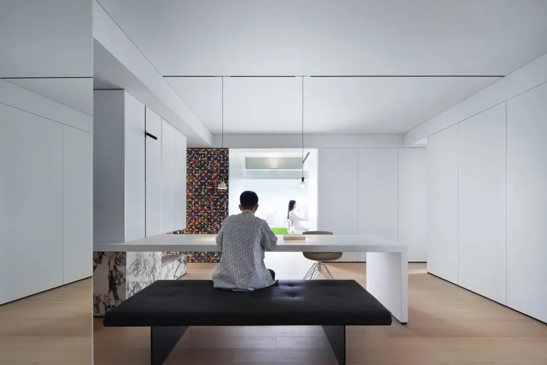 A modern living room with white furniture and minimalist design.