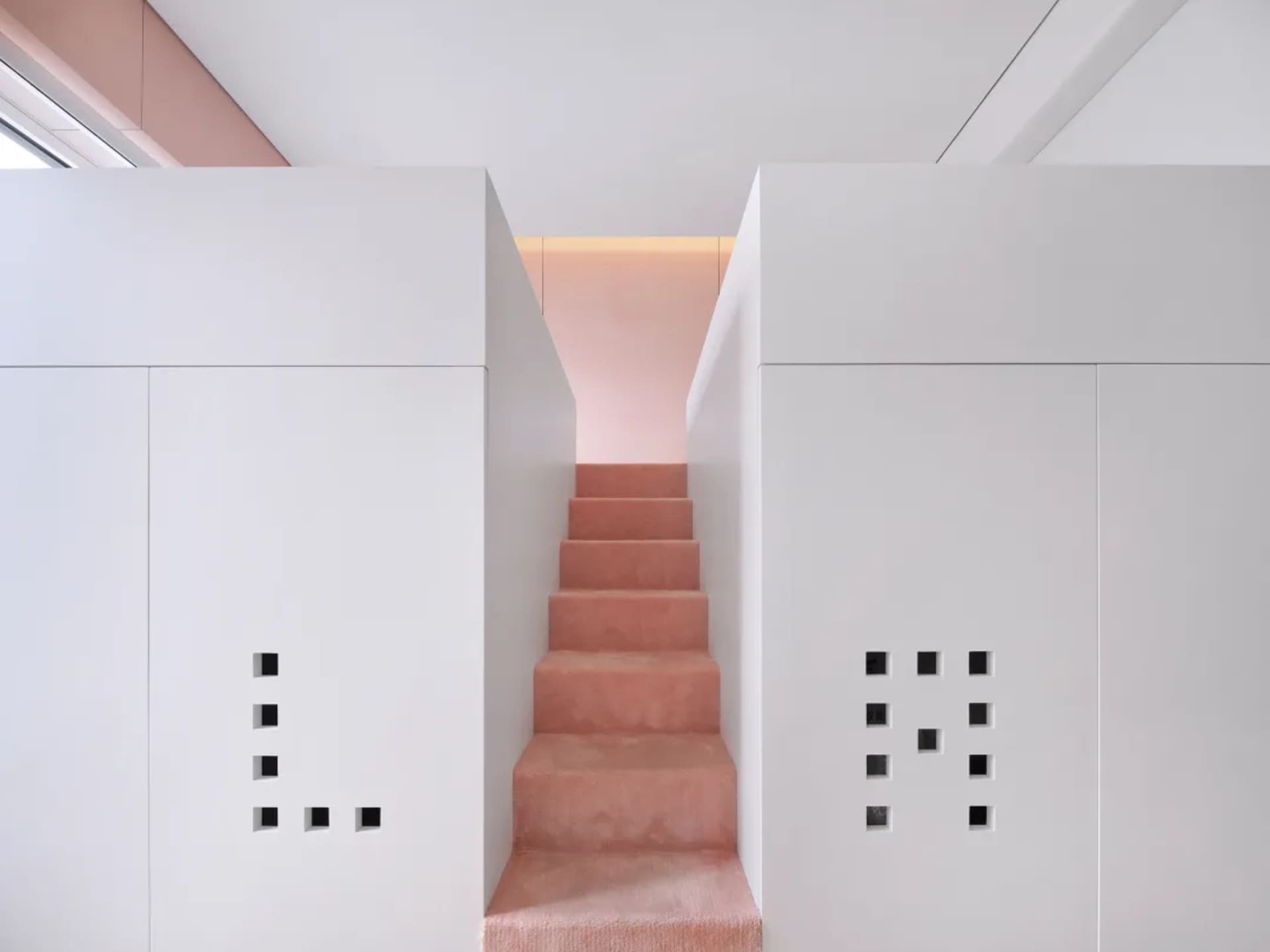 Modern minimalist staircase with concrete steps and white walls