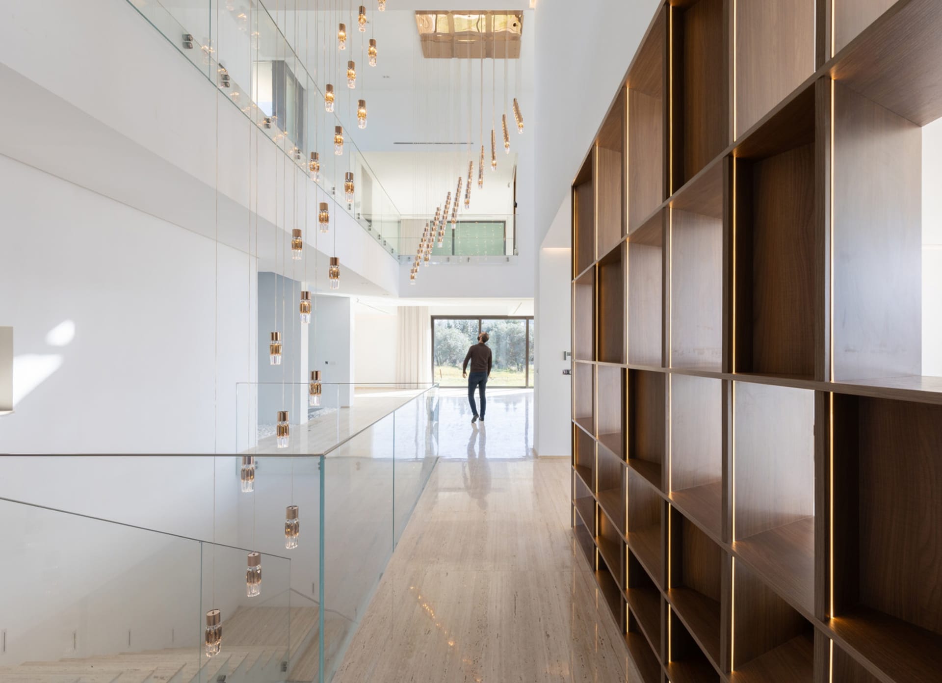 Modern interior with glass walls, wooden shelves, and minimalist design.