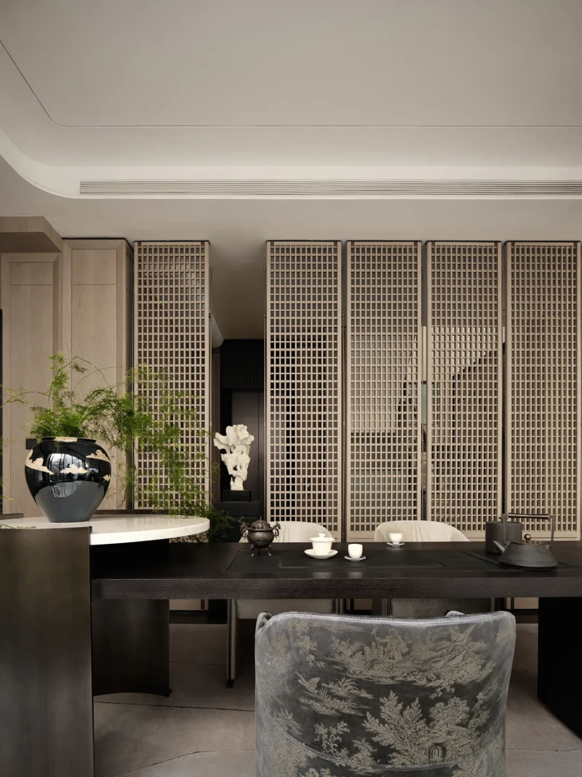 Modern living room featuring a wooden table and wall panels.