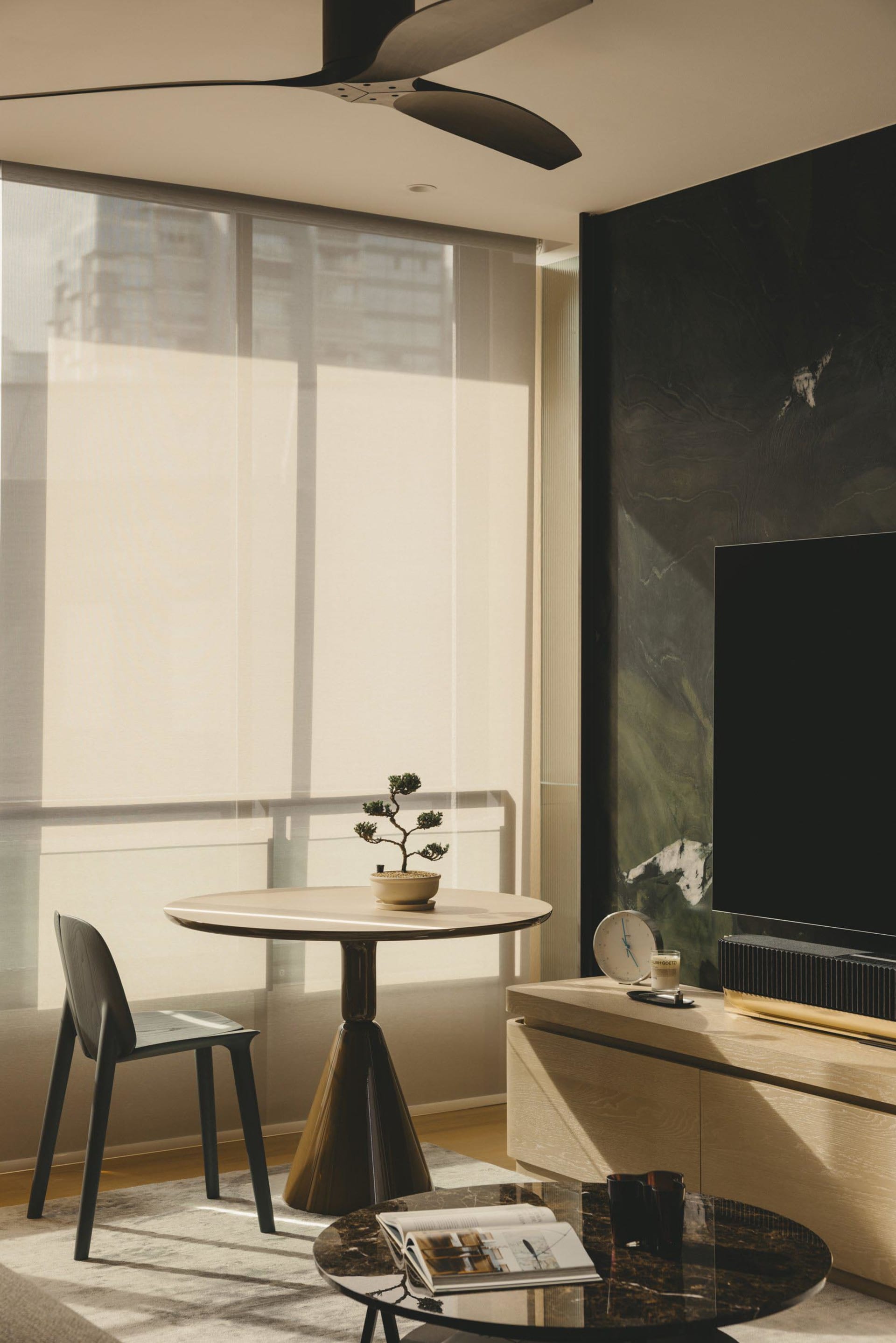 Modern minimalist living room featuring sleek marble and metallic finishes.