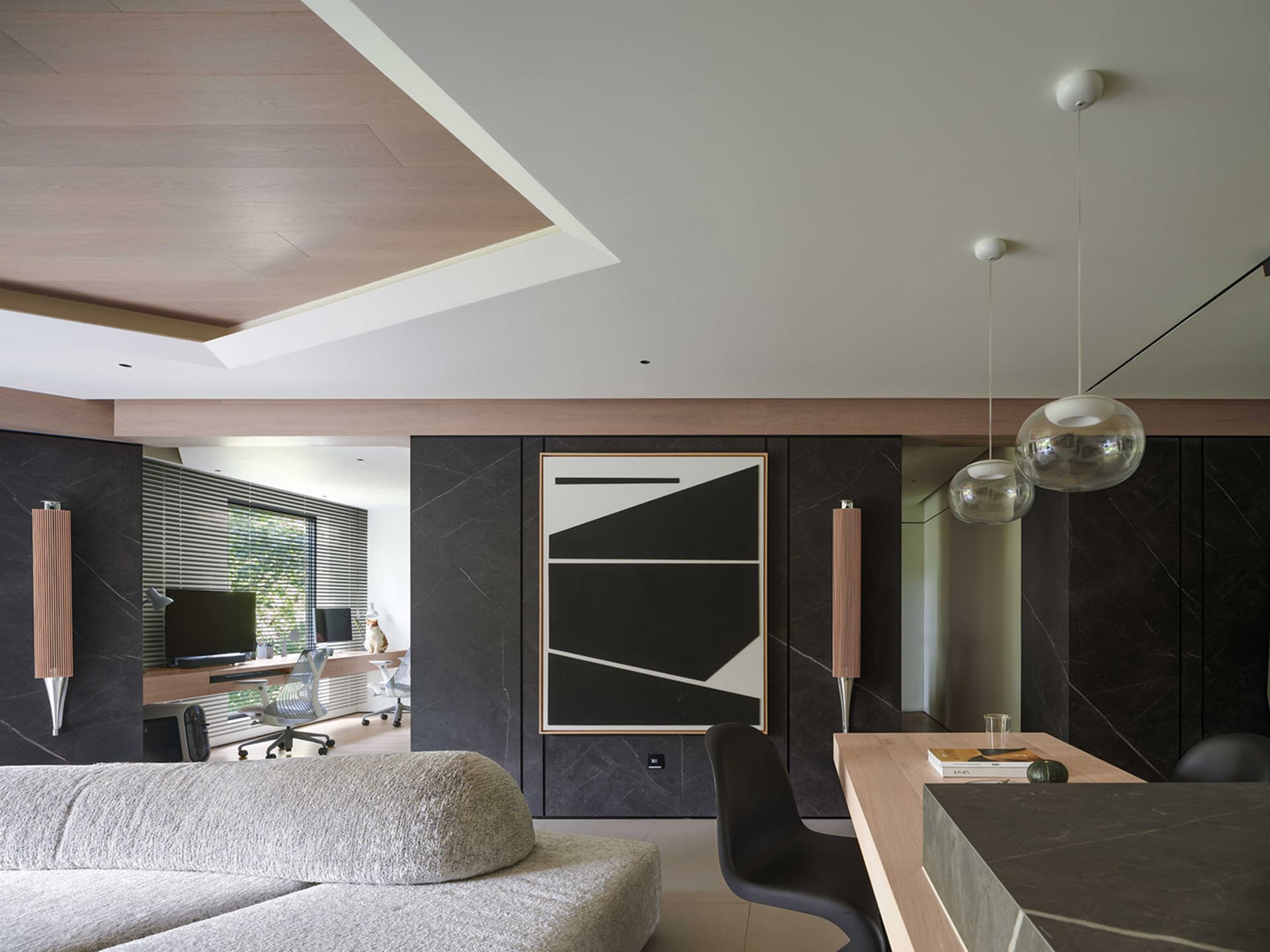A modern living room featuring stone walls and a minimalist design.