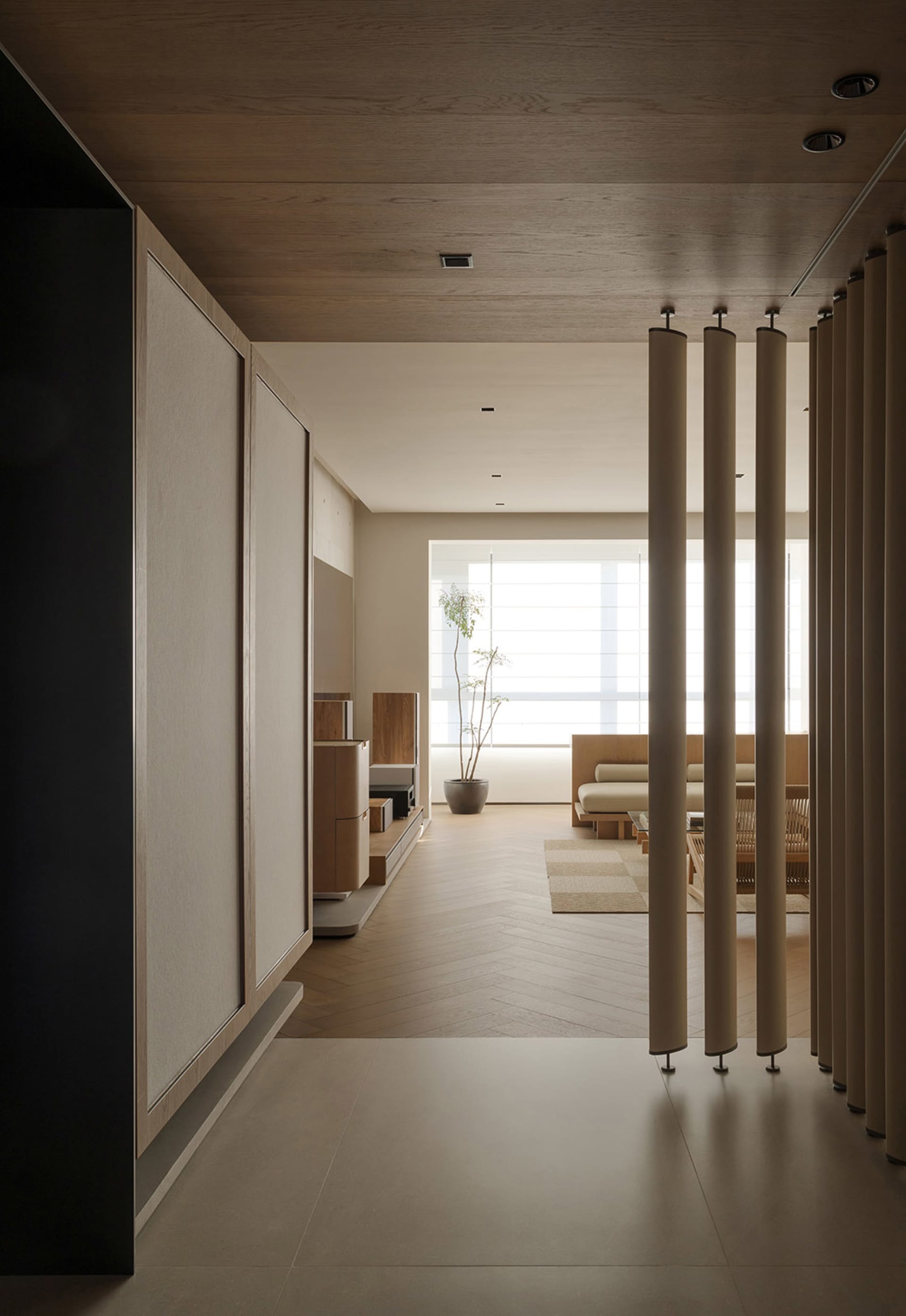 Modern living room with wooden flooring and minimalist decor.