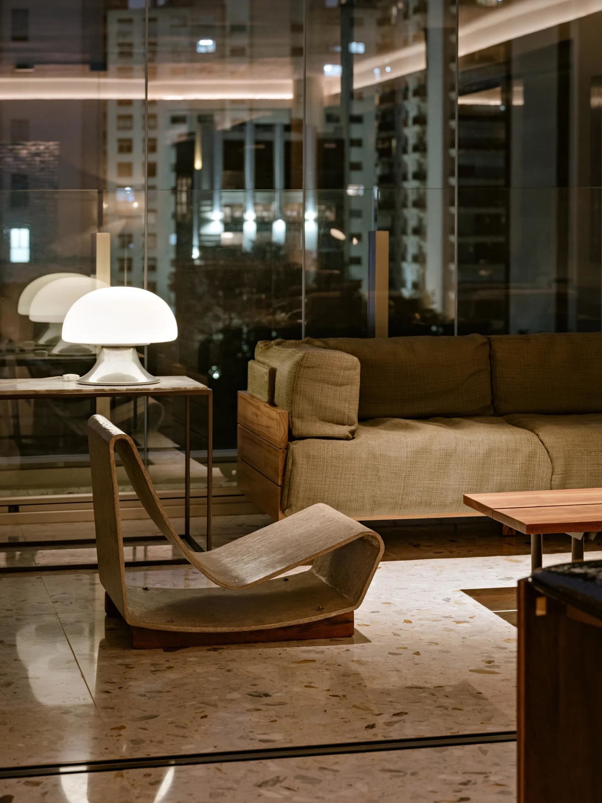 Modern living room with a wooden sofa, lamp, and coffee table.