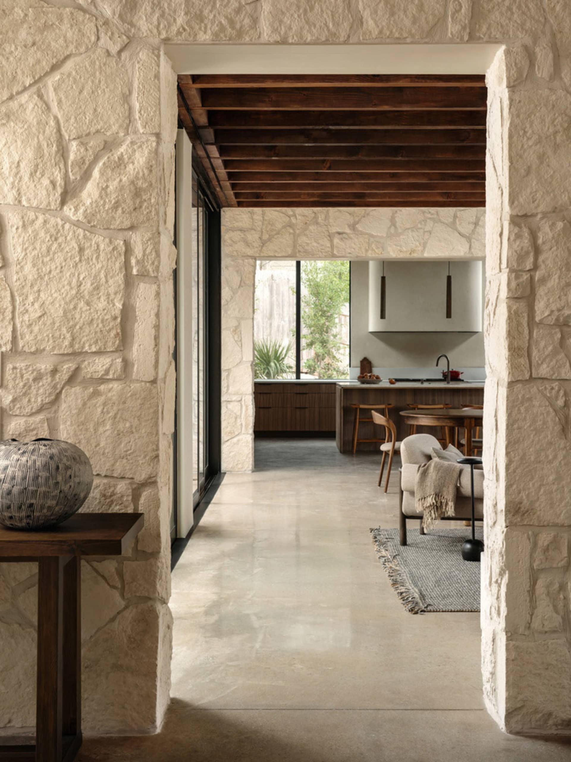 A modern kitchen with concrete finishes and industrial details, featuring minimalist design and a clean, open layout.