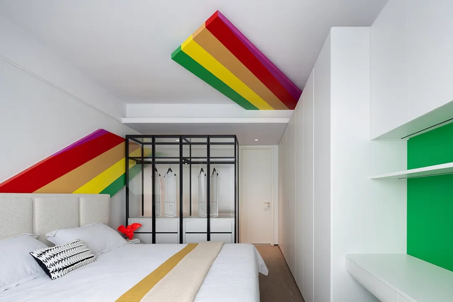 Modern bedroom with white walls, colorful ceiling accents, and a glass-door wardrobe.