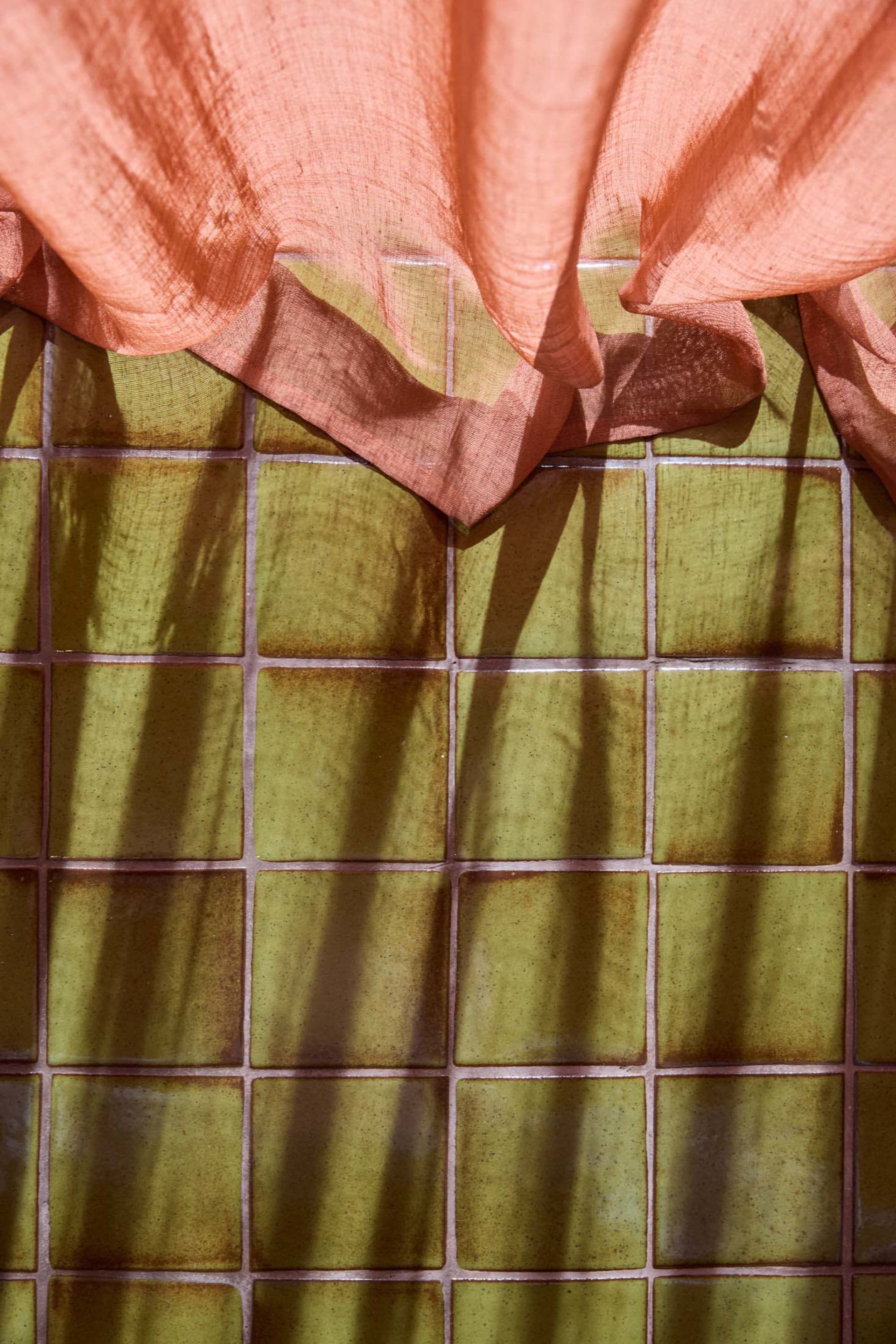 Ceramic tiles arranged in a grid pattern on a floor.