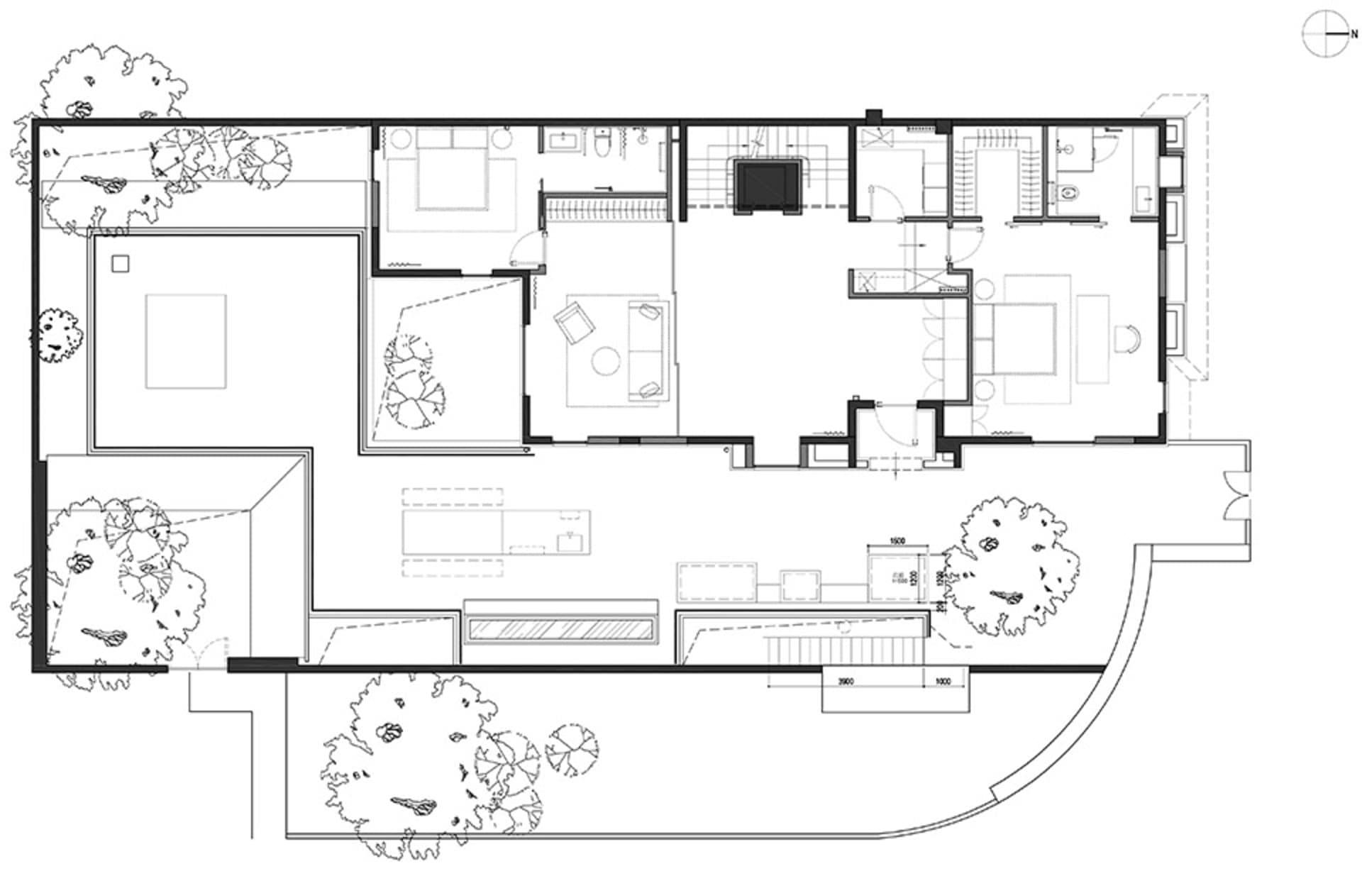 Black and white architectural drawing of a modern house layout with several rooms and outdoor space.