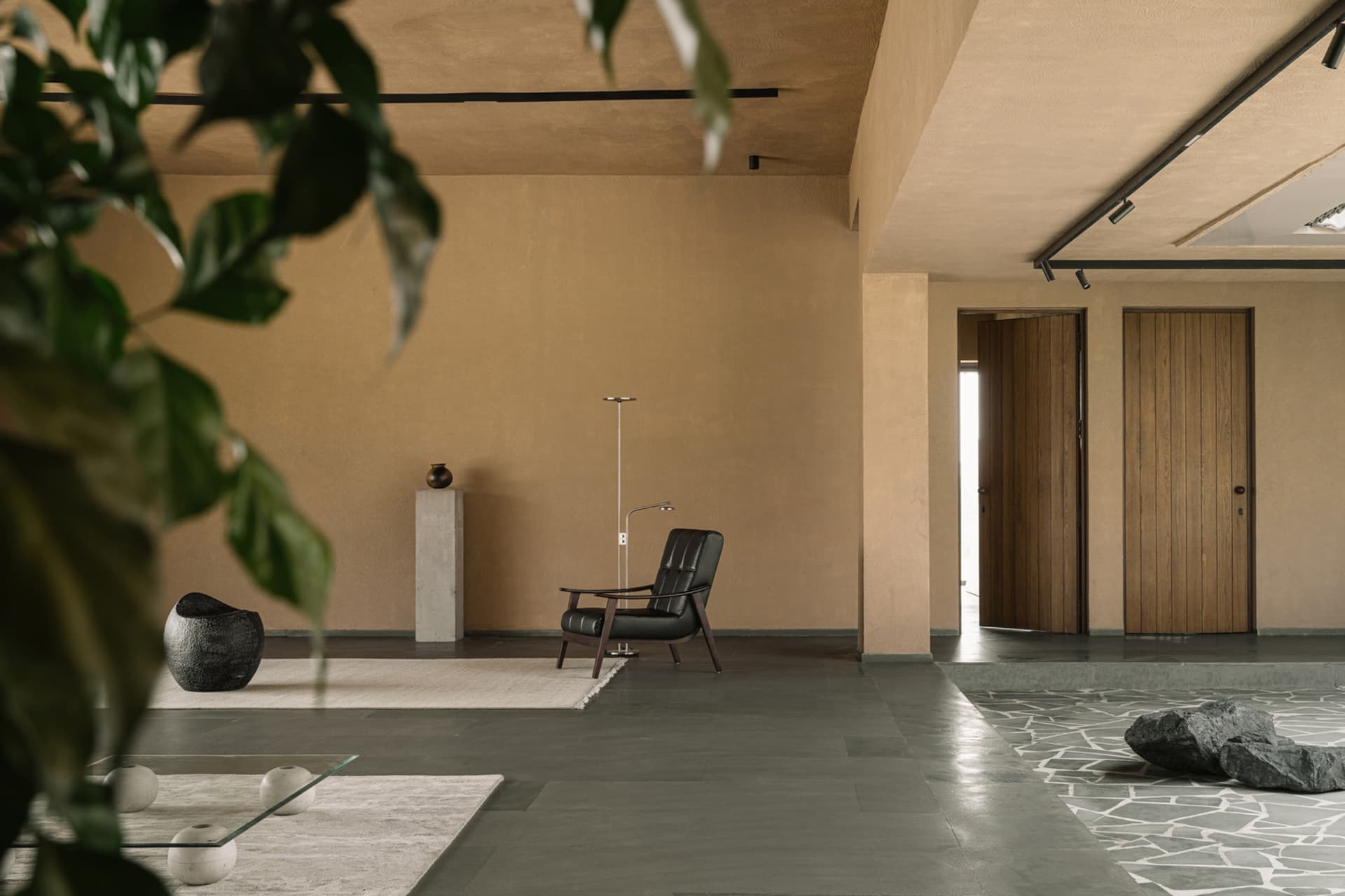 A modern living room featuring a concrete floor and minimalist design