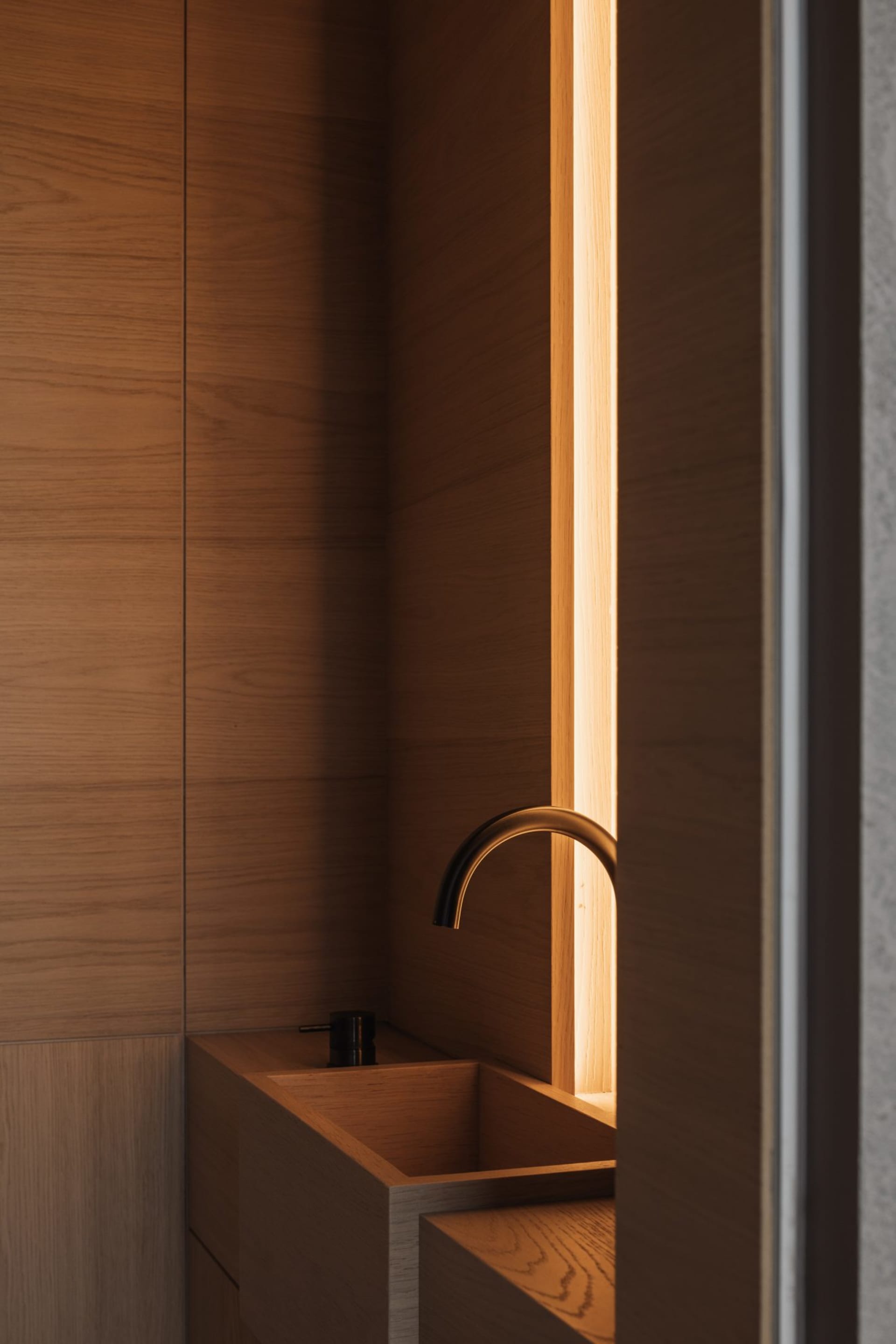 Modern bathroom with wooden finishes and minimalist design.