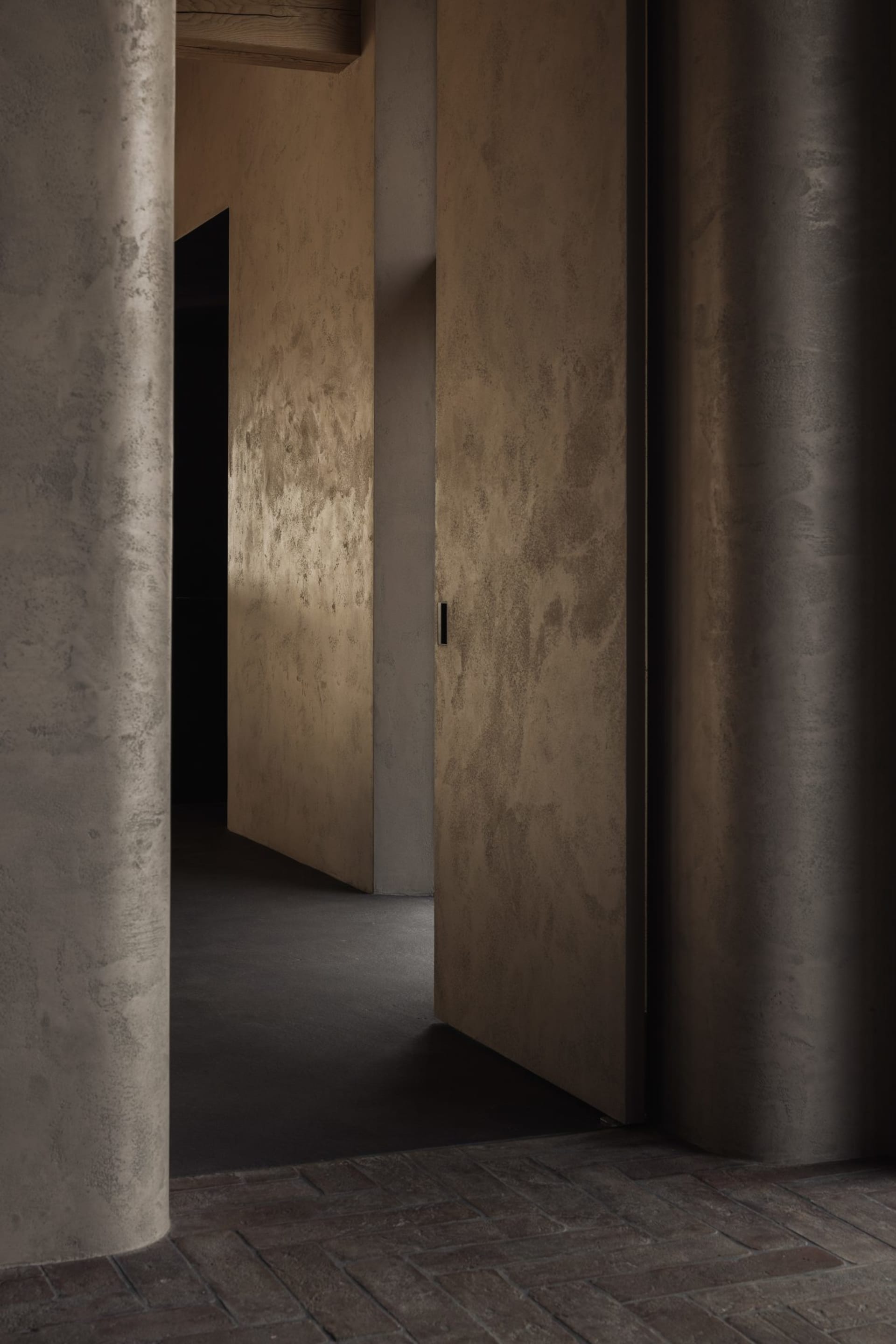 A modern, minimalist interior space with concrete walls and flooring.