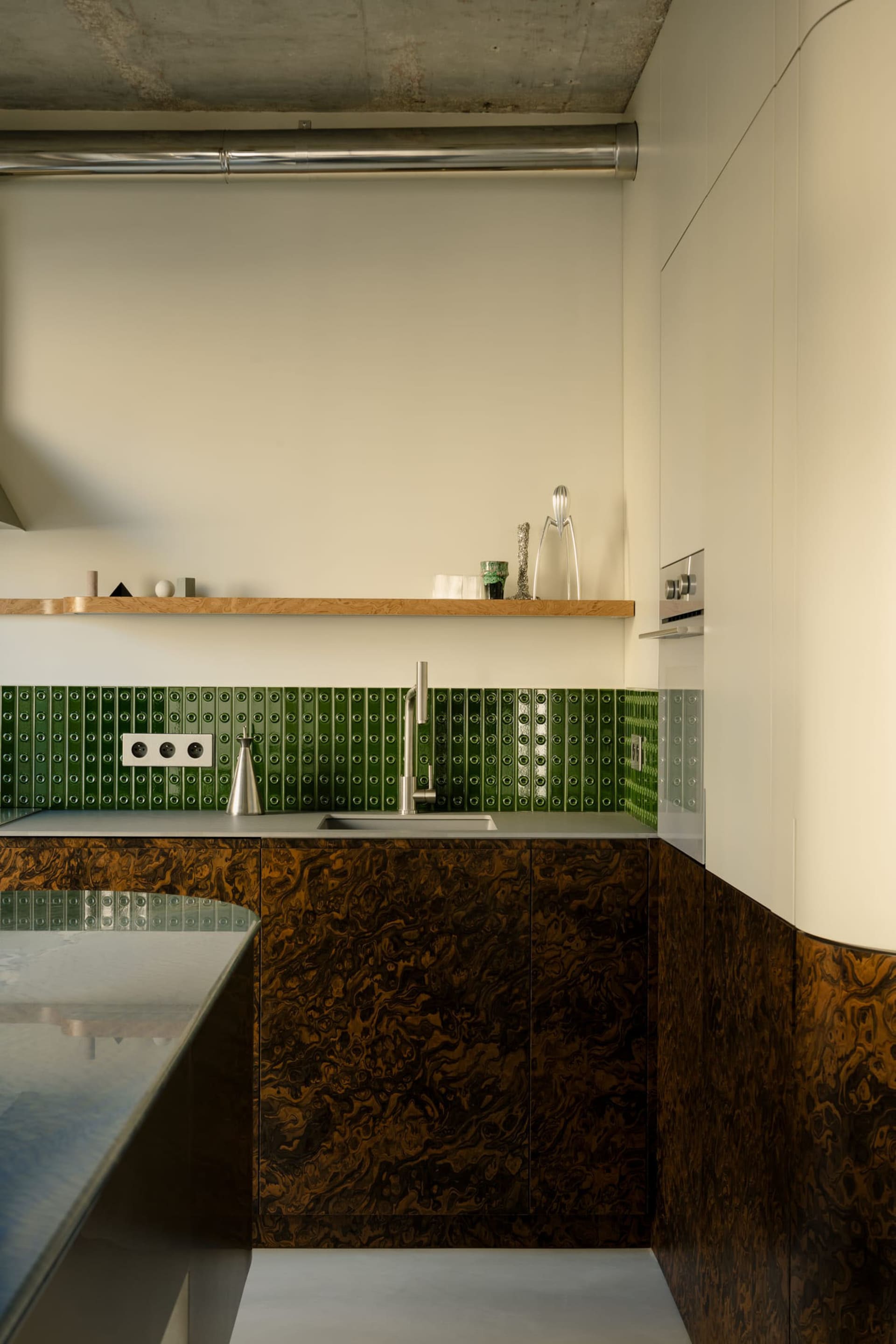 Modern kitchen featuring marble countertops and backsplash