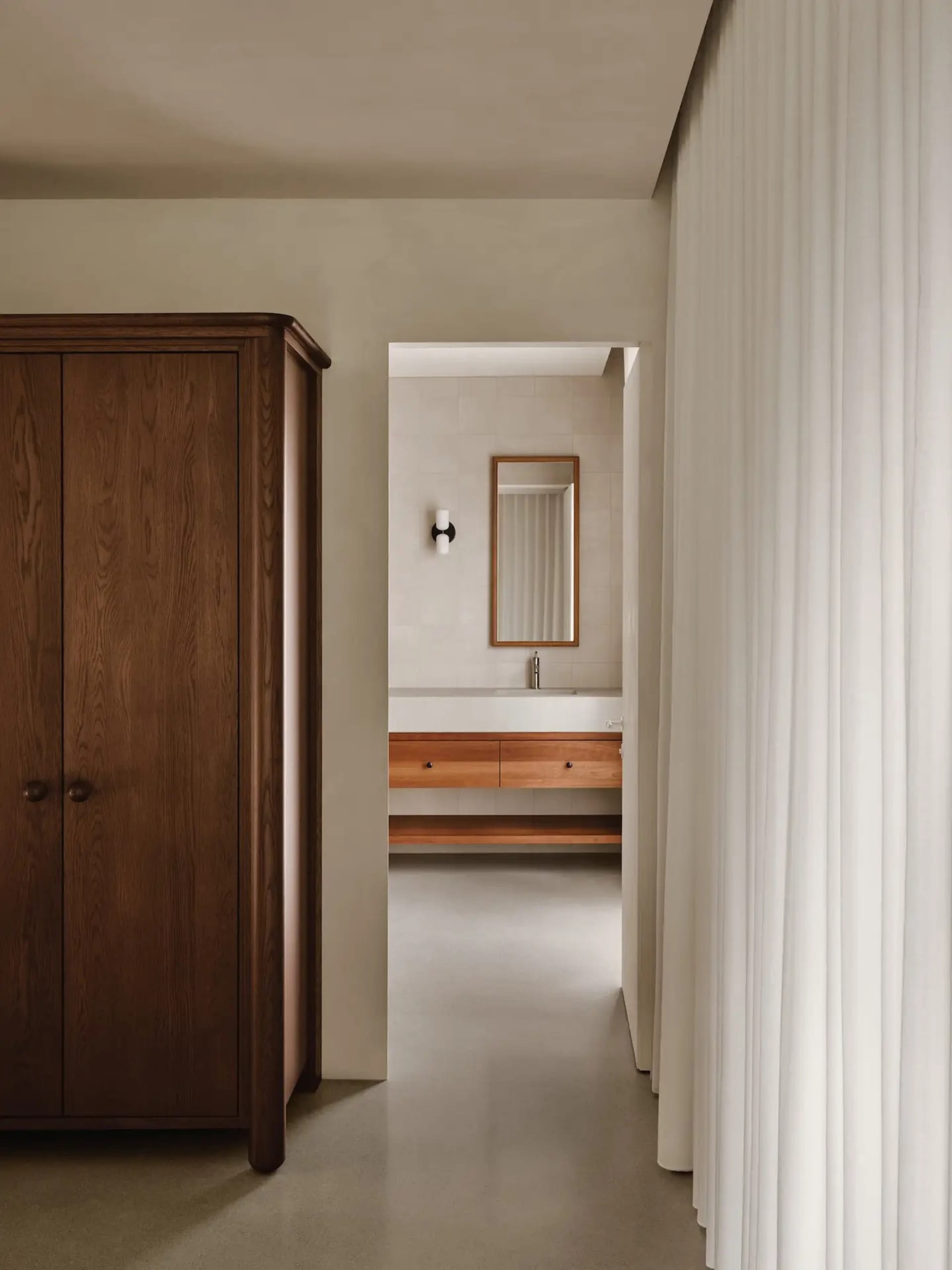 Minimalist bathroom with concrete walls and wooden vanity