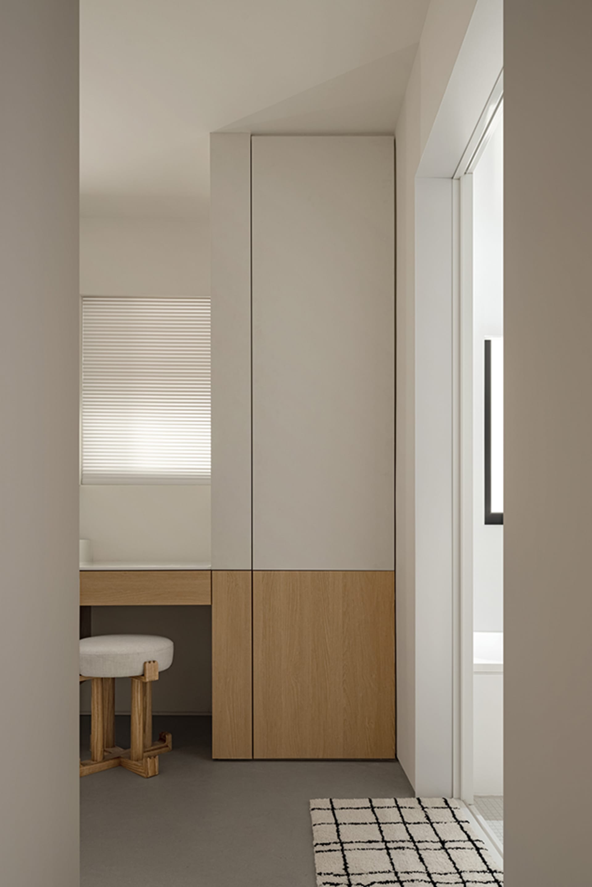 A modern minimalist cabinet in a studio apartment with a simple design and clean lines.
