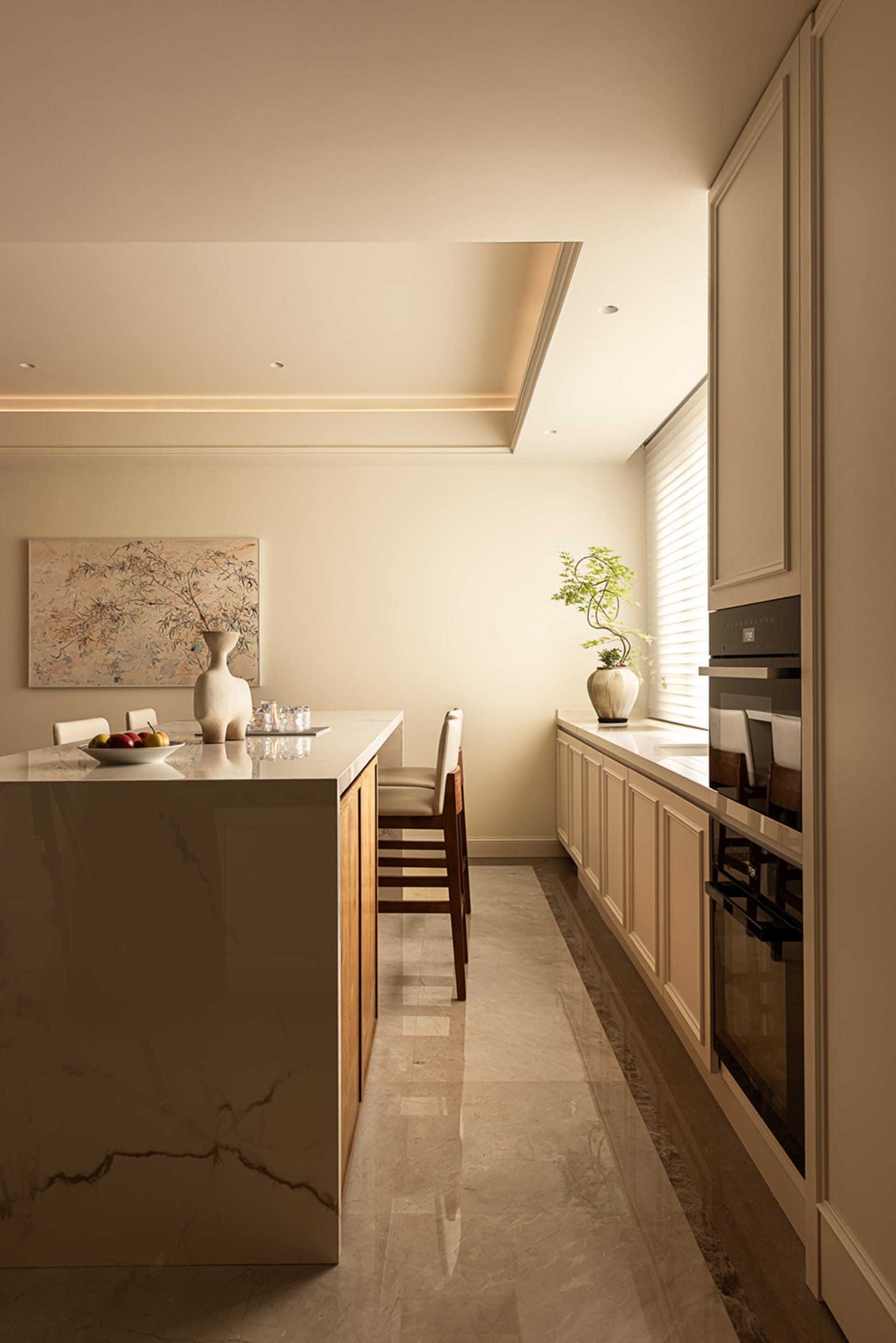 Modern, minimalist residential kitchen featuring marble countertops and flooring