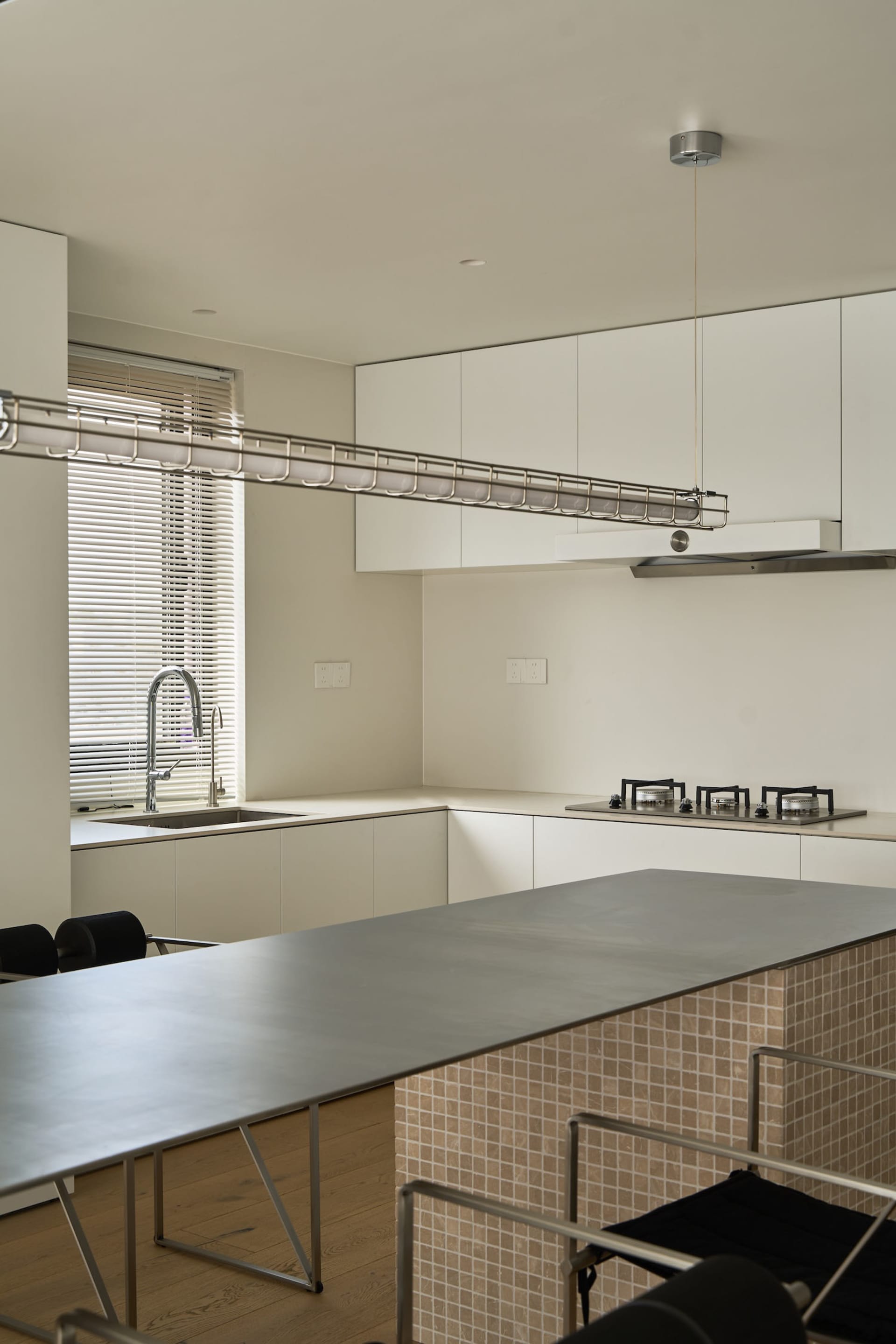 A modern kitchen featuring a sleek metal countertop with minimalist design elements.
