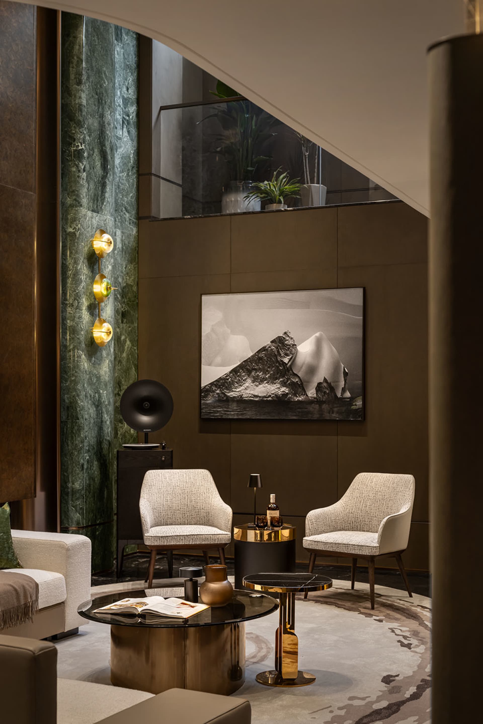 Modern living room with marble floor, metallic chairs, and fabric seating.