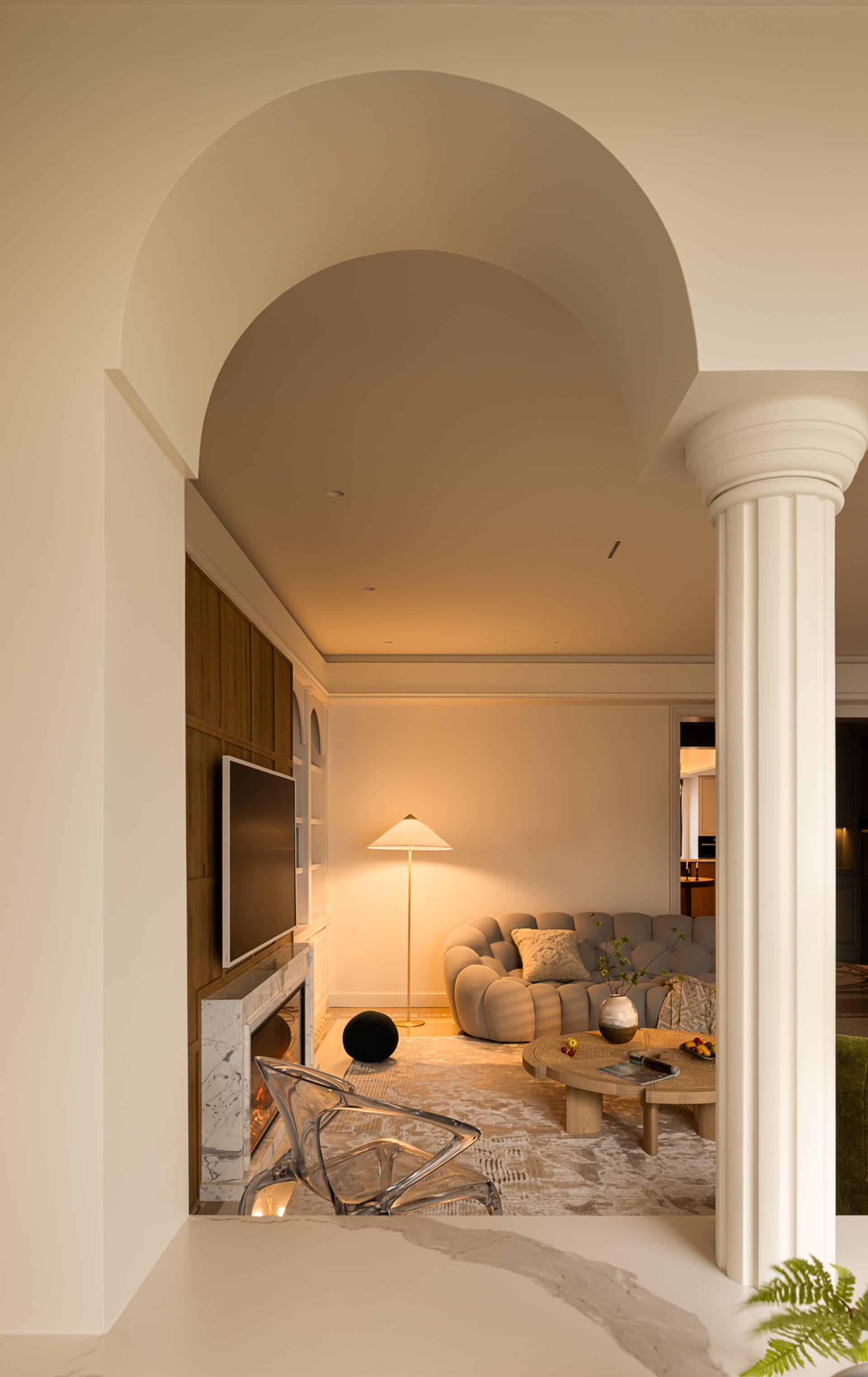 A modern living room with neutral-toned furniture and a warm, inviting atmosphere