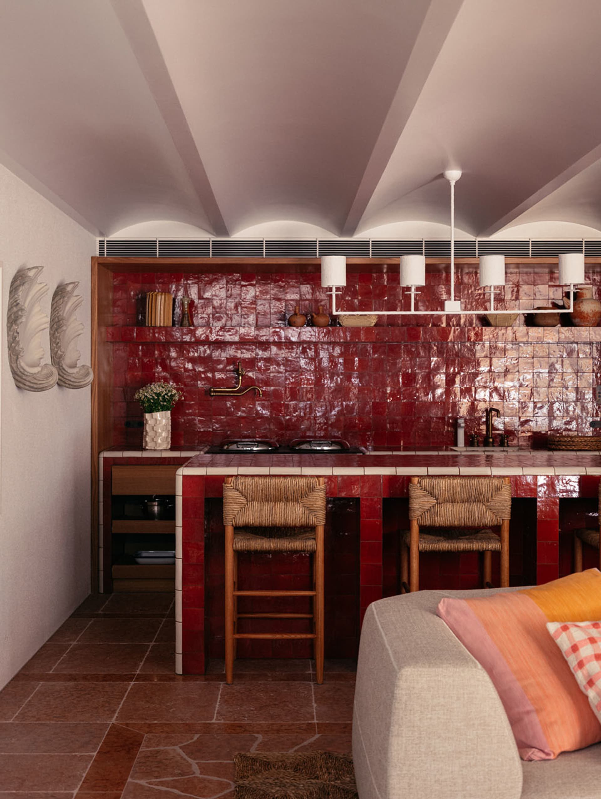 Modern kitchen with red tile backsplash and white countertops.