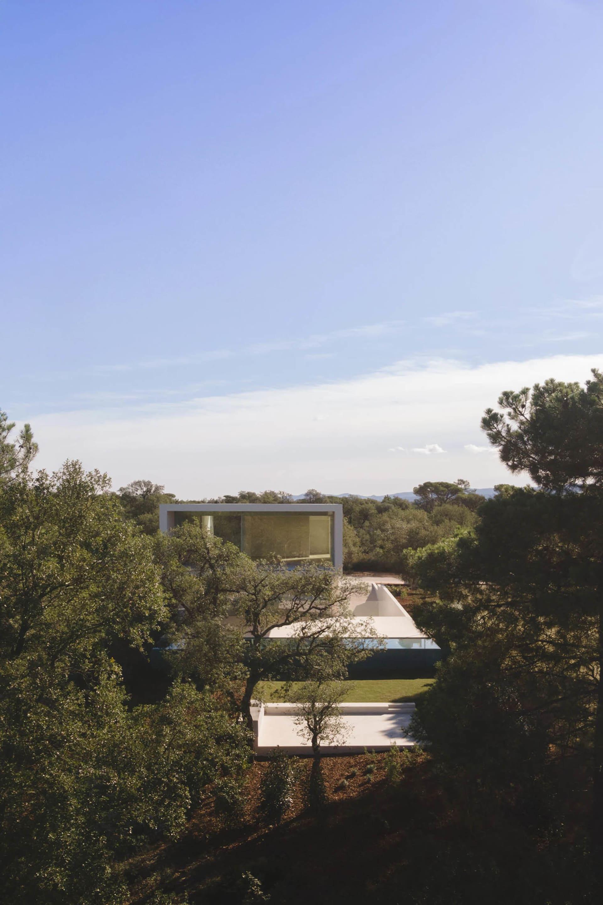 Modern house featuring glass and concrete materials, minimalist architectural style