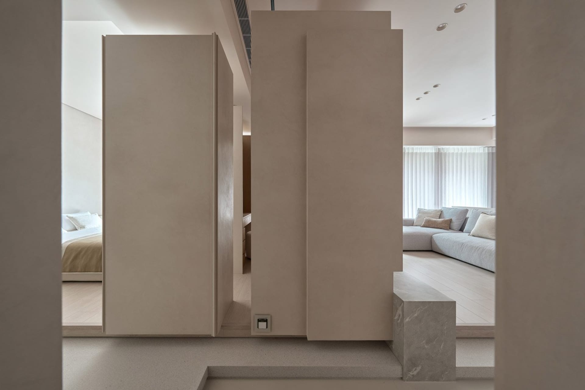Modern living room featuring concrete sections and minimalist design.