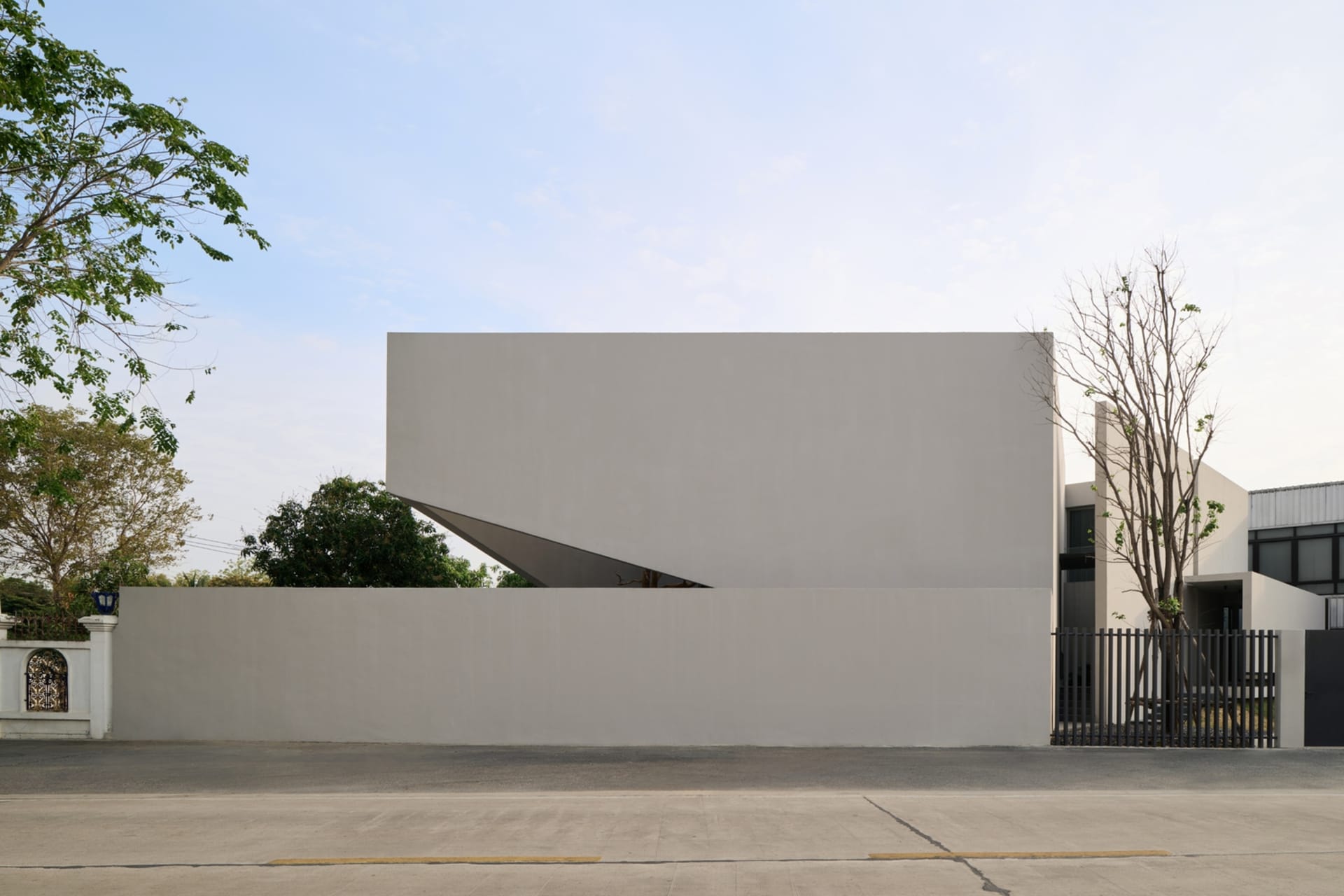 A modern exterior of a house with a solid concrete wall.