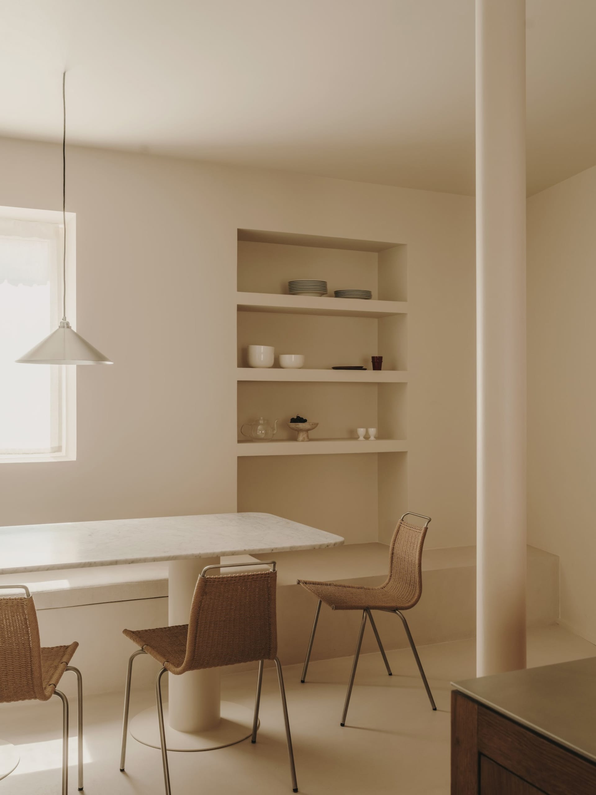 Minimalist living room with marble table and woven chairs