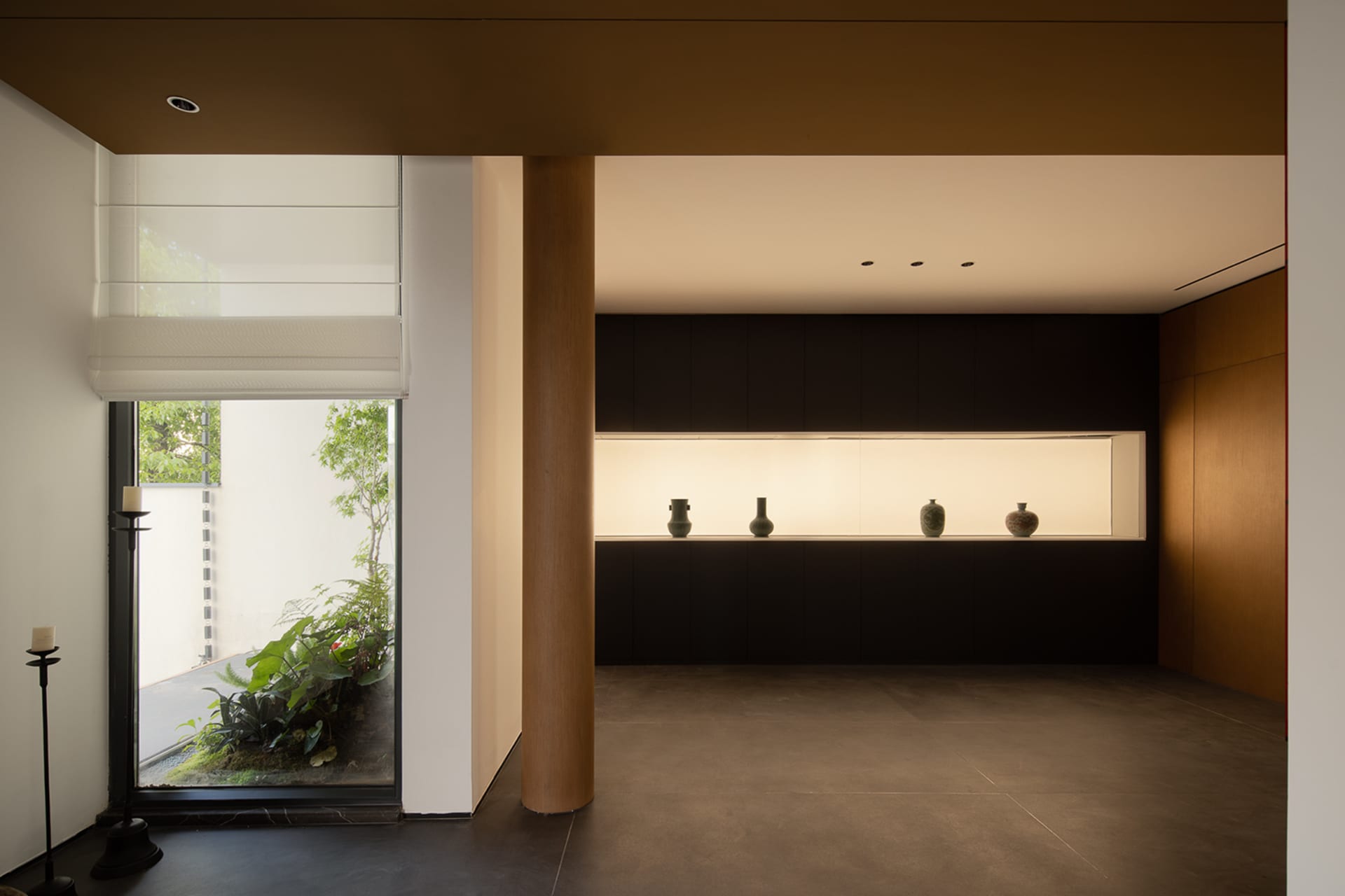 Minimalist living space with concrete walls and wooden accents.