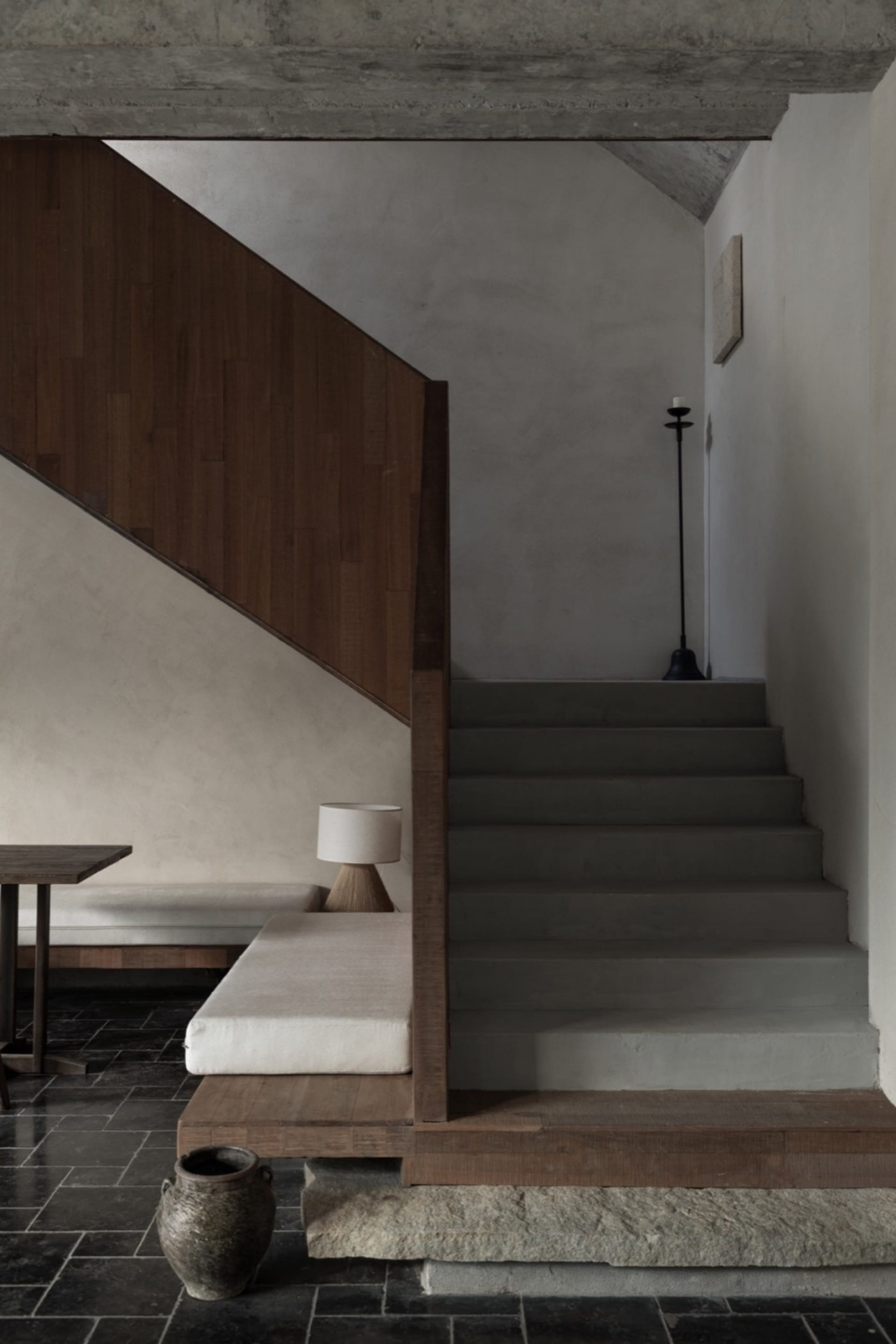 Modern interior design featuring concrete tiling and wooden elements.