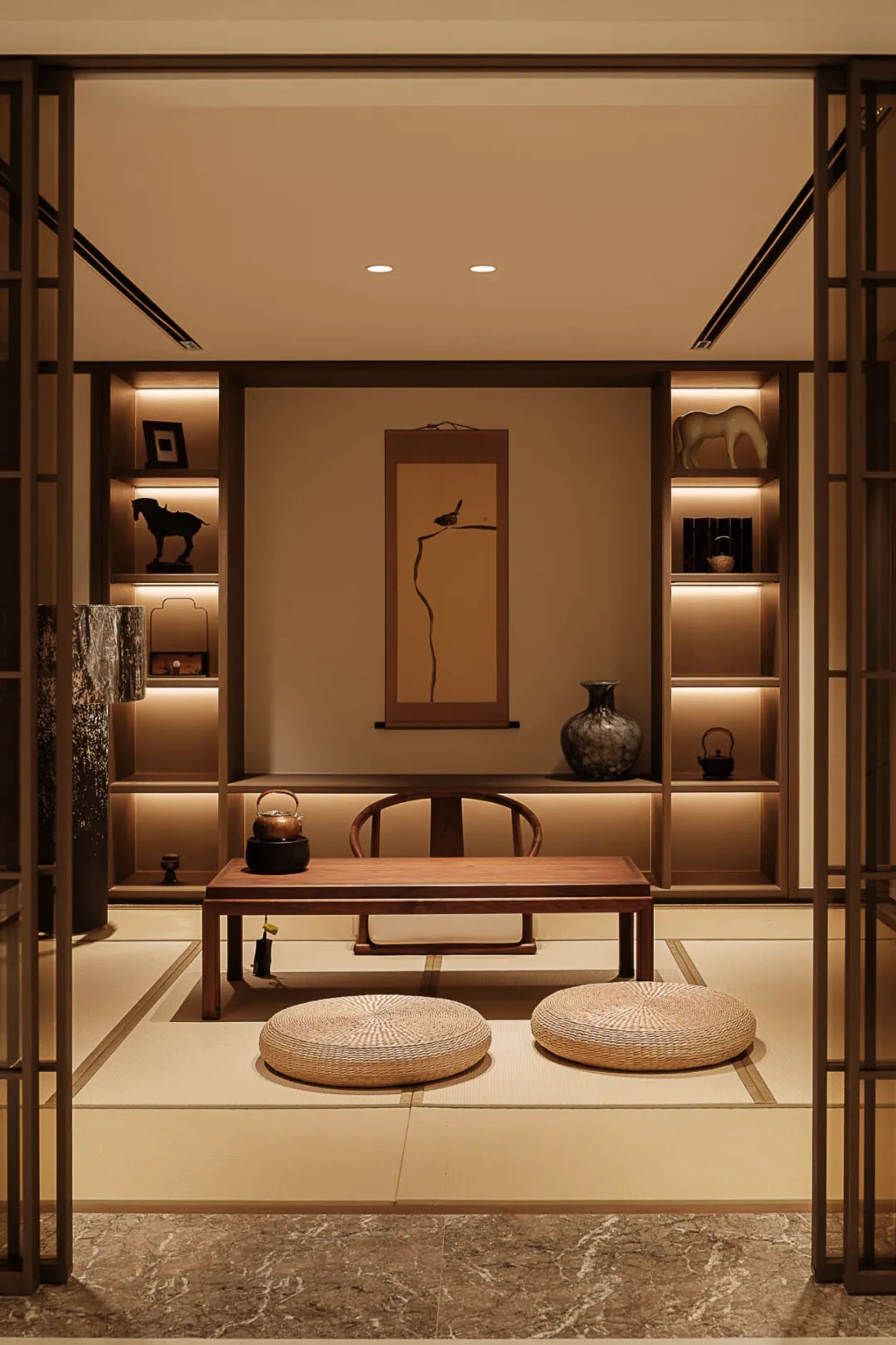 A modern small room interior with minimalist design, featuring wooden furniture and lighting on the wall.