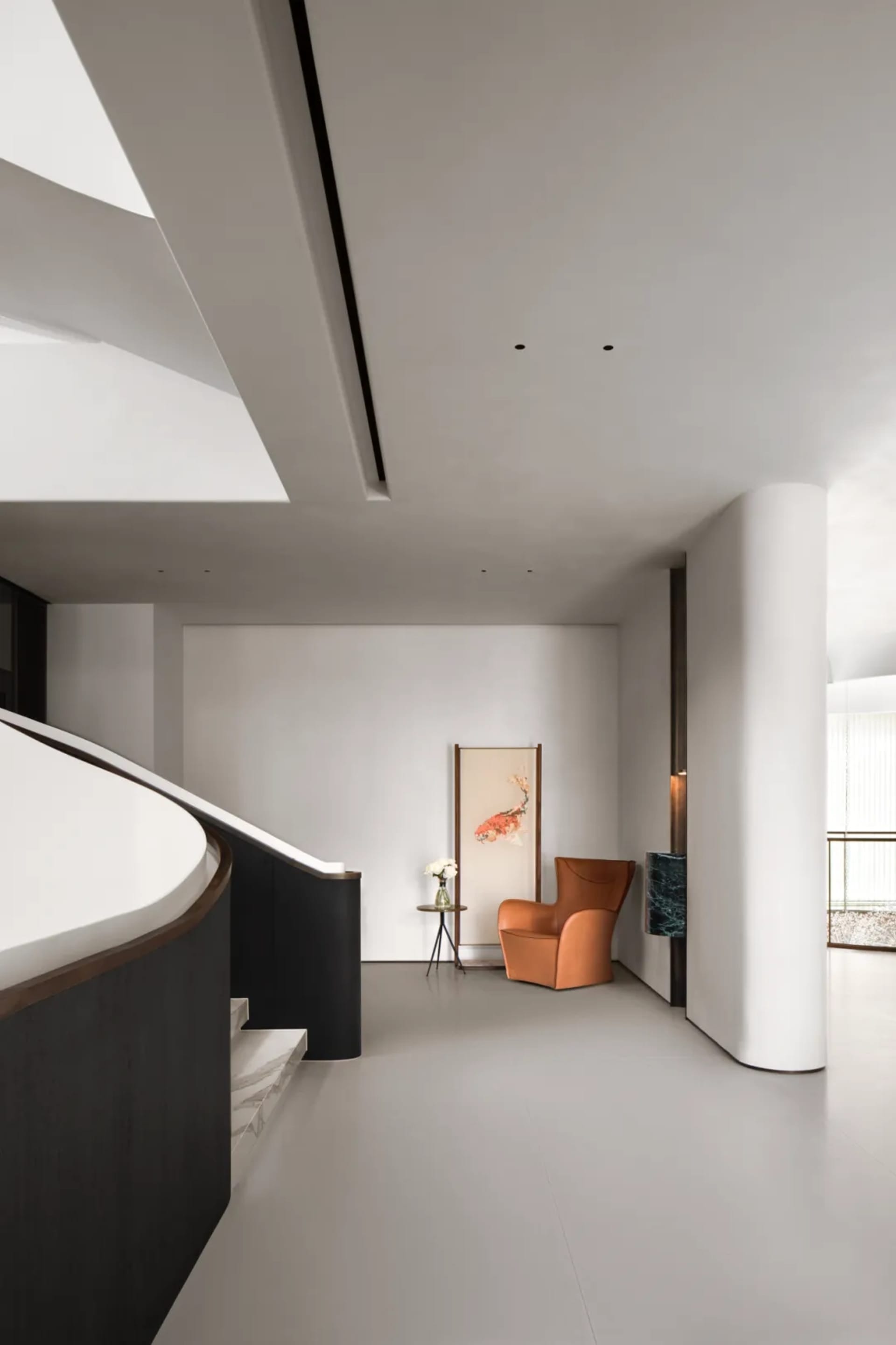 A modern home entryway featuring a sleek, minimalist design with a concrete floor and wall.