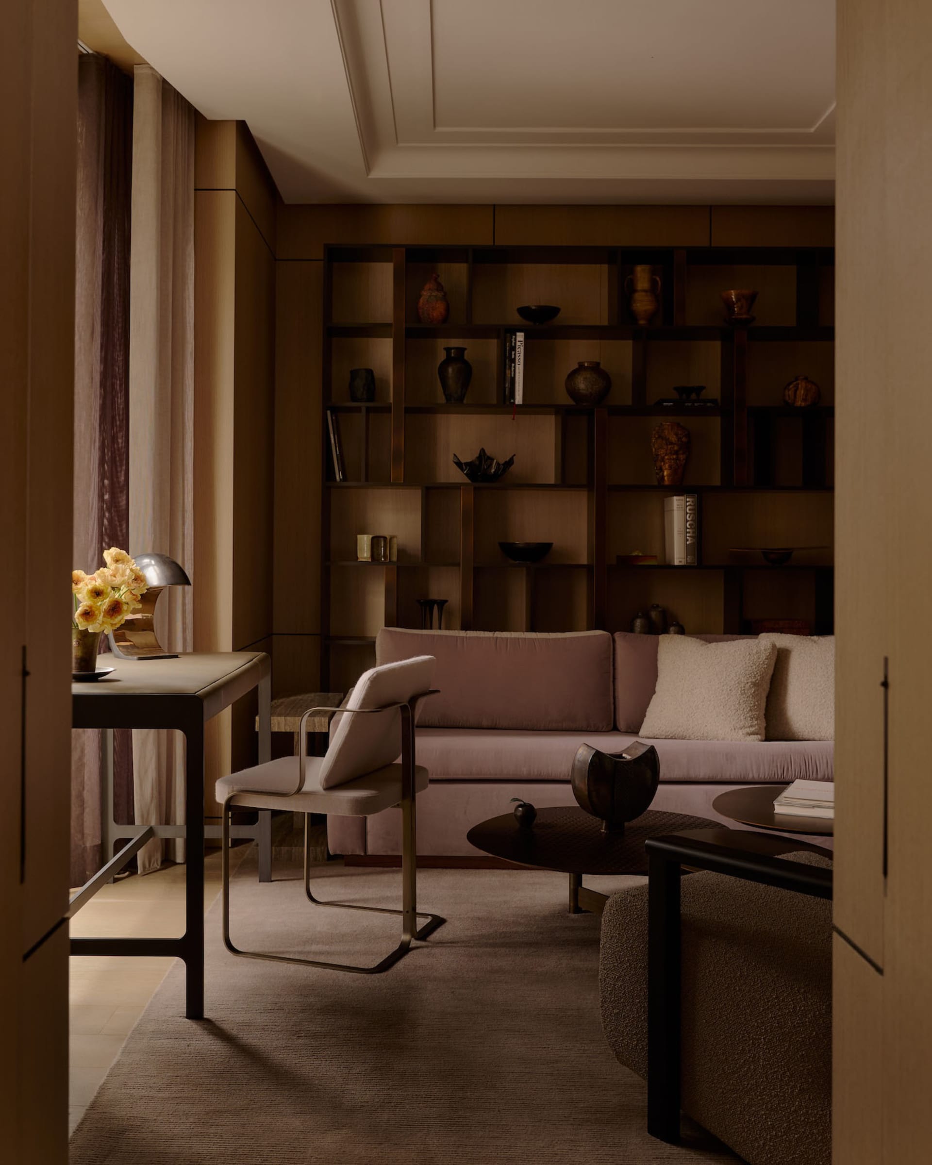 Modern living room featuring fabric seating, metal accents, and wooden elements.