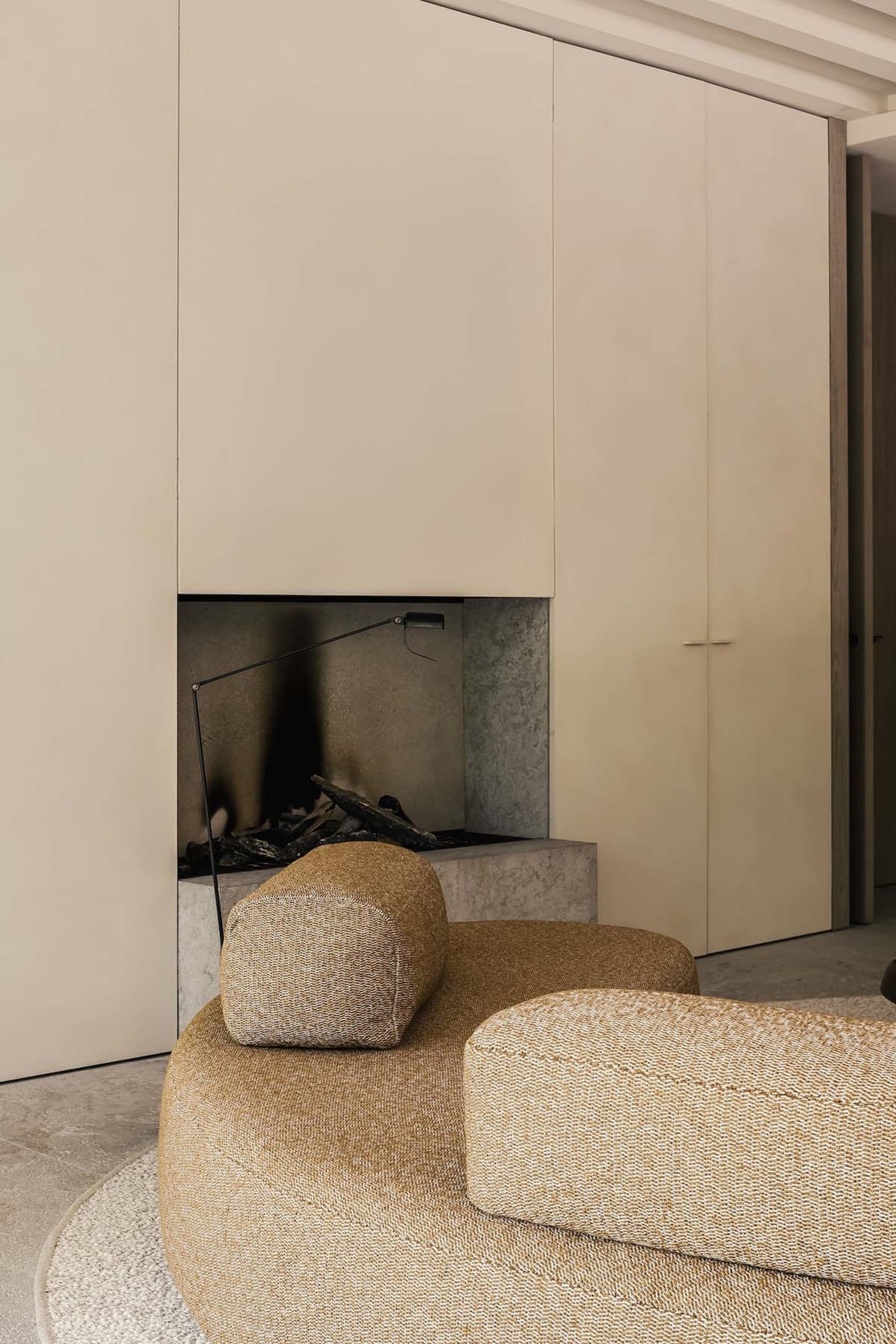Modern minimalist living room featuring fabric seating and concrete fireplace