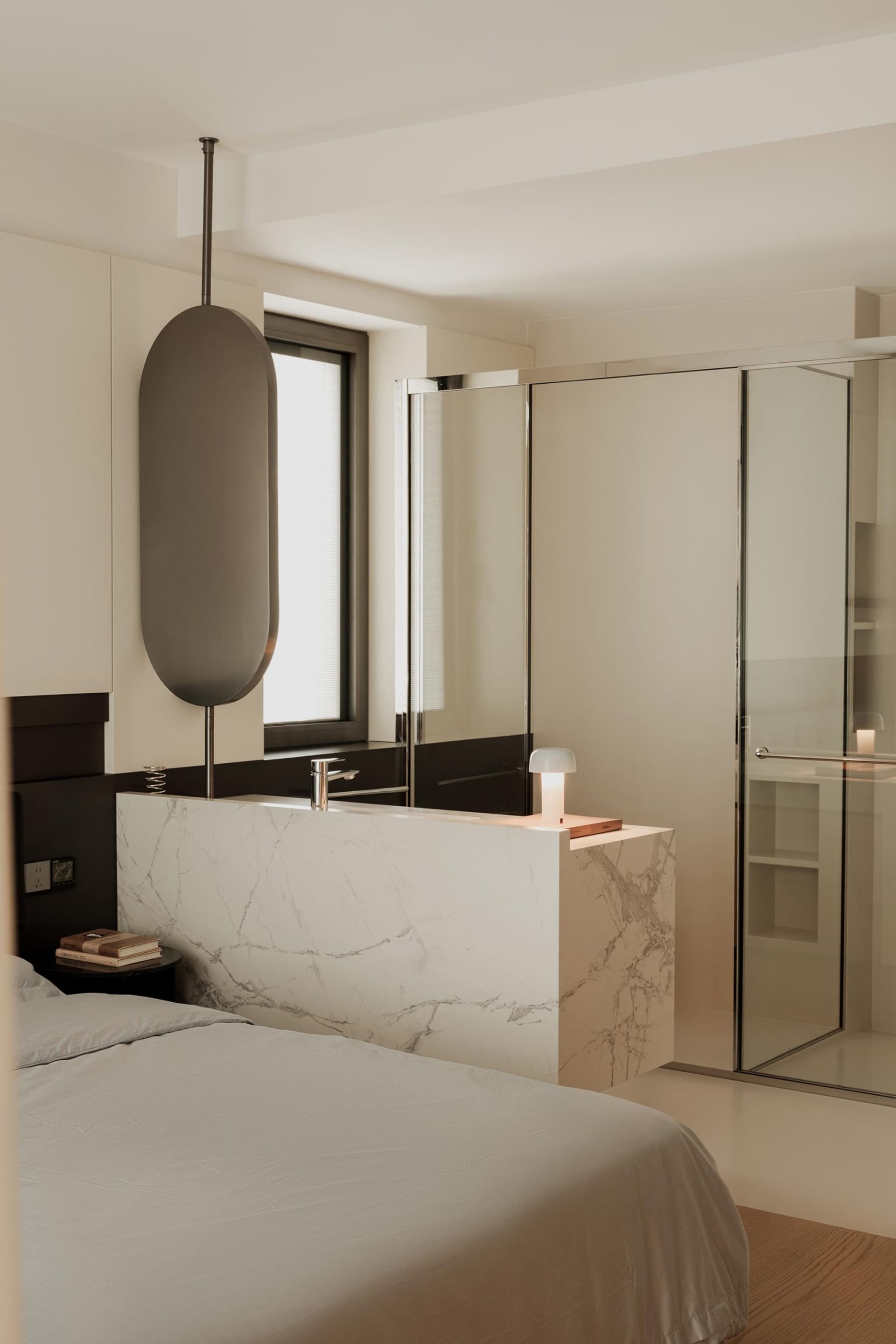 Modern bathroom with marble countertops and glass walk-in shower.