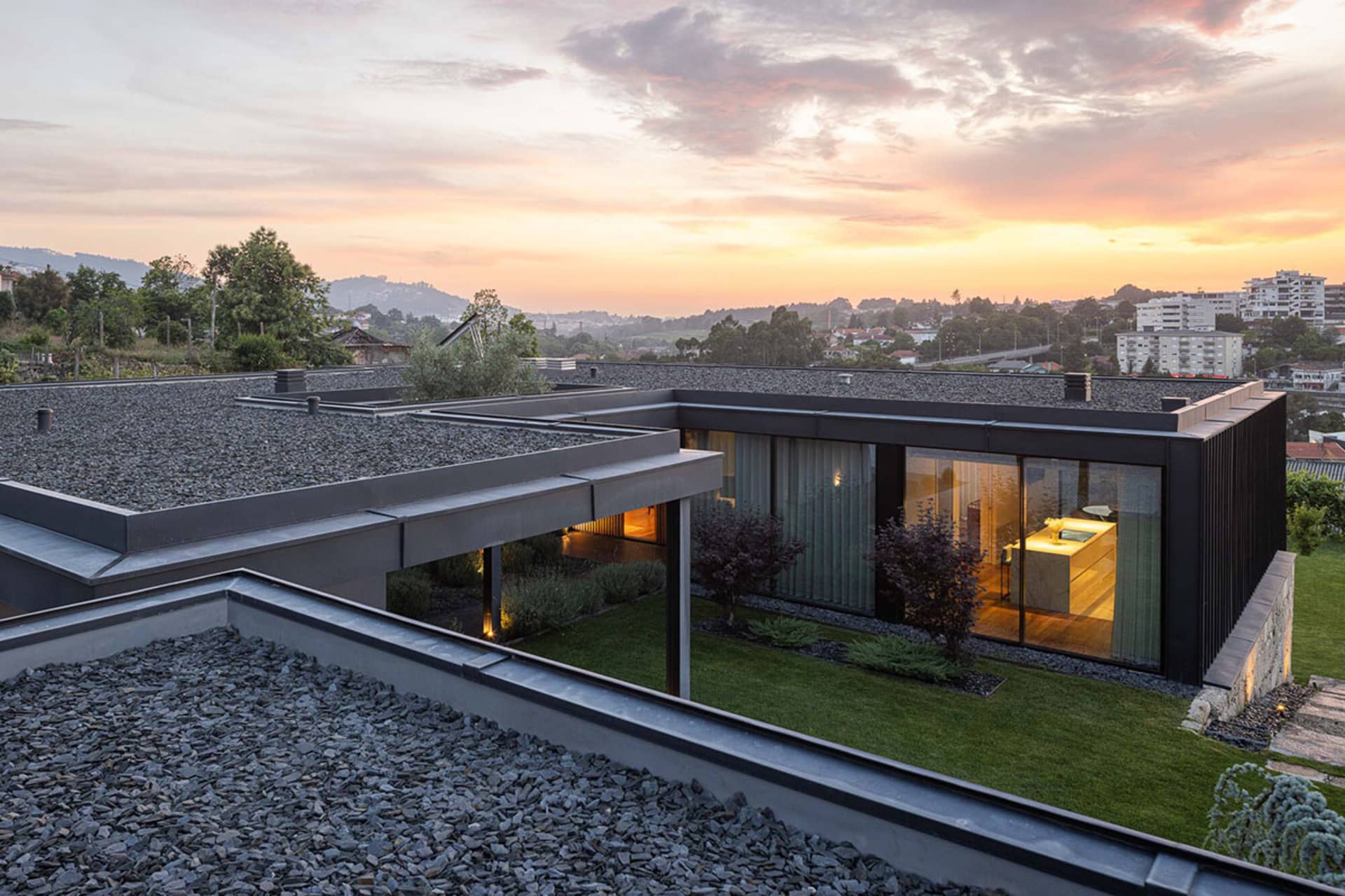 Modern minimalist house exterior with glass walls and concrete elements