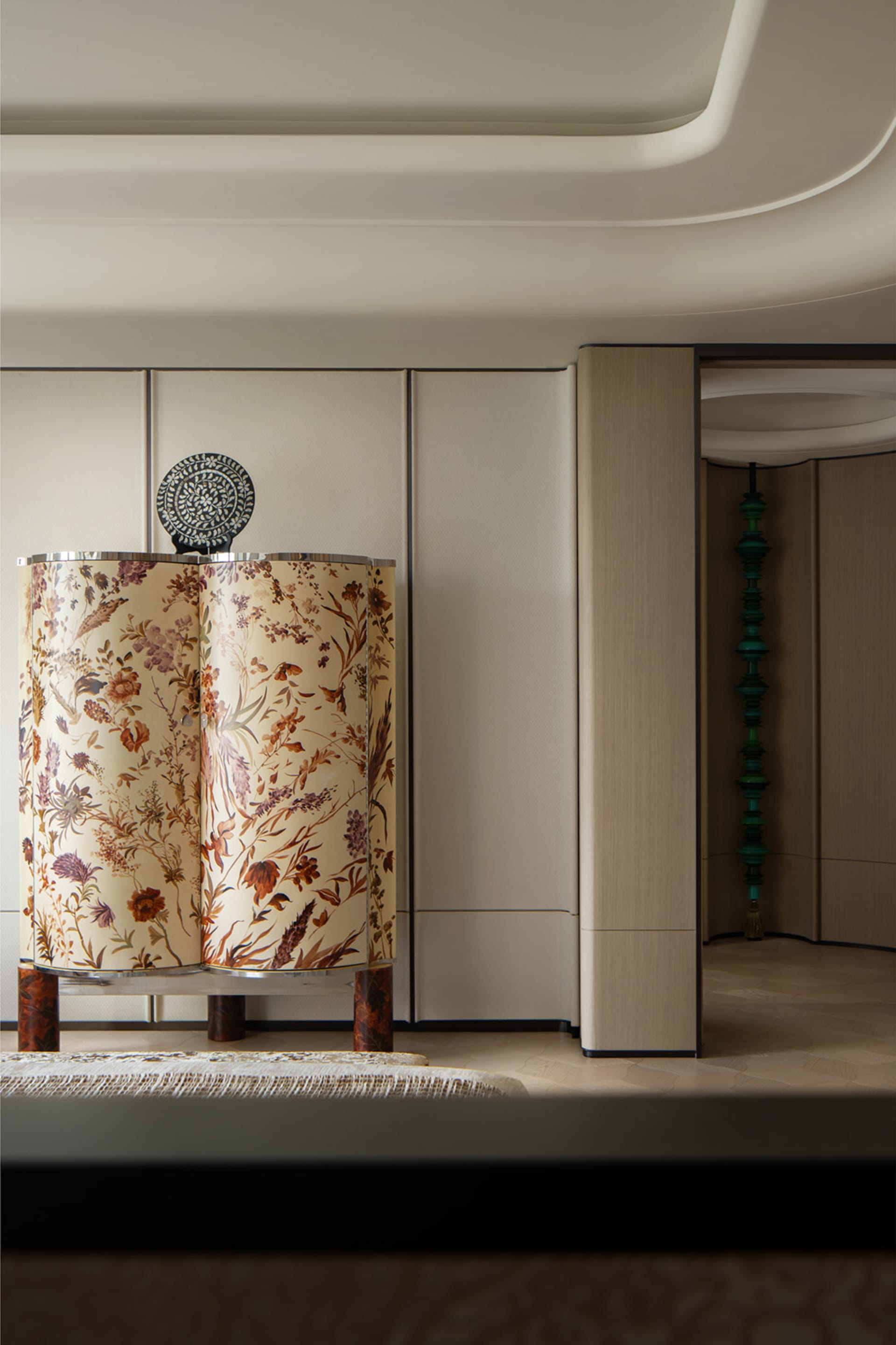 A fabric curtain in a living room with a pattern of wildflowers.