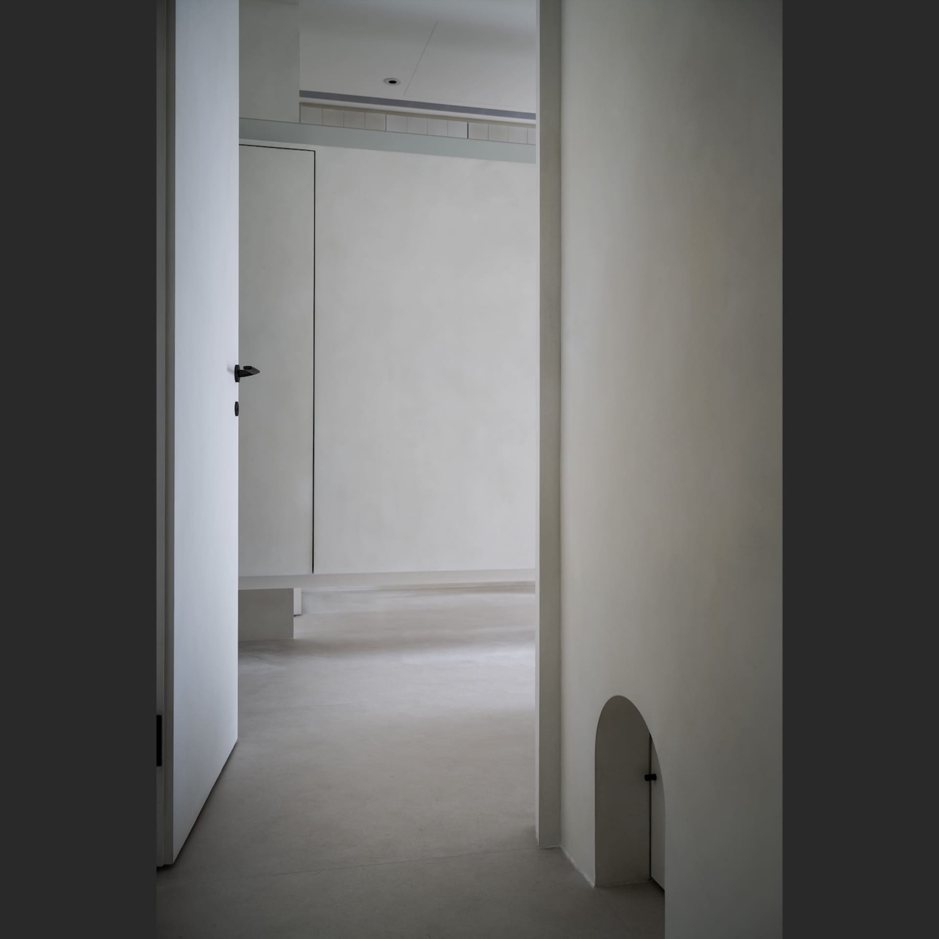 A minimalist concrete interior space with simple design elements and white walls.